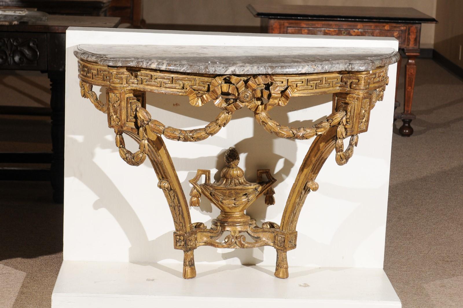 Transitional Louis XV/XVI giltwood wall-mounted console table with Greek key, swag, & urn detail, France, ca. 1770.
   