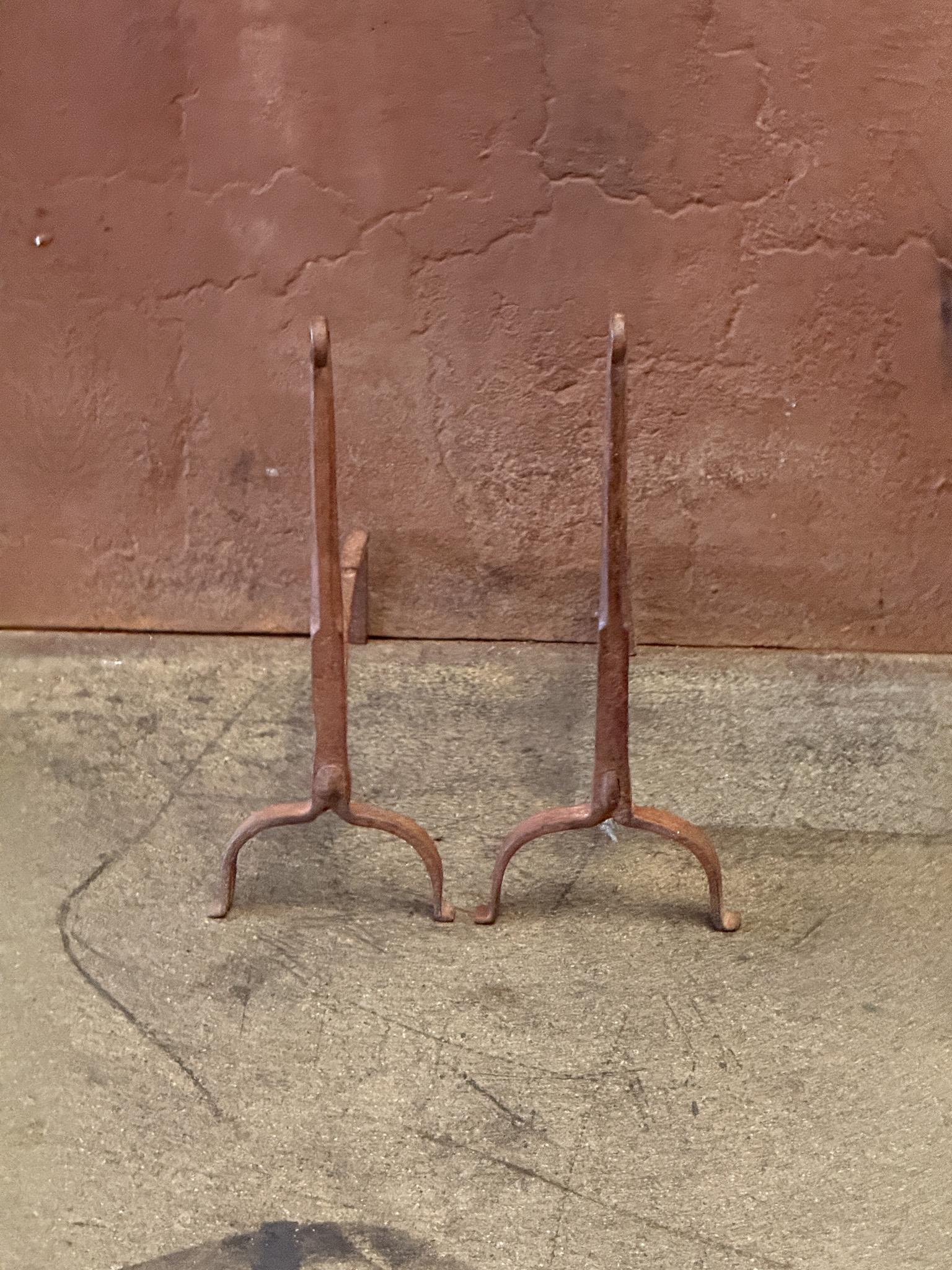 18th Century French Gothic Period andirons made of wrought iron. The andirons have a natural brown patina. The condition is good.