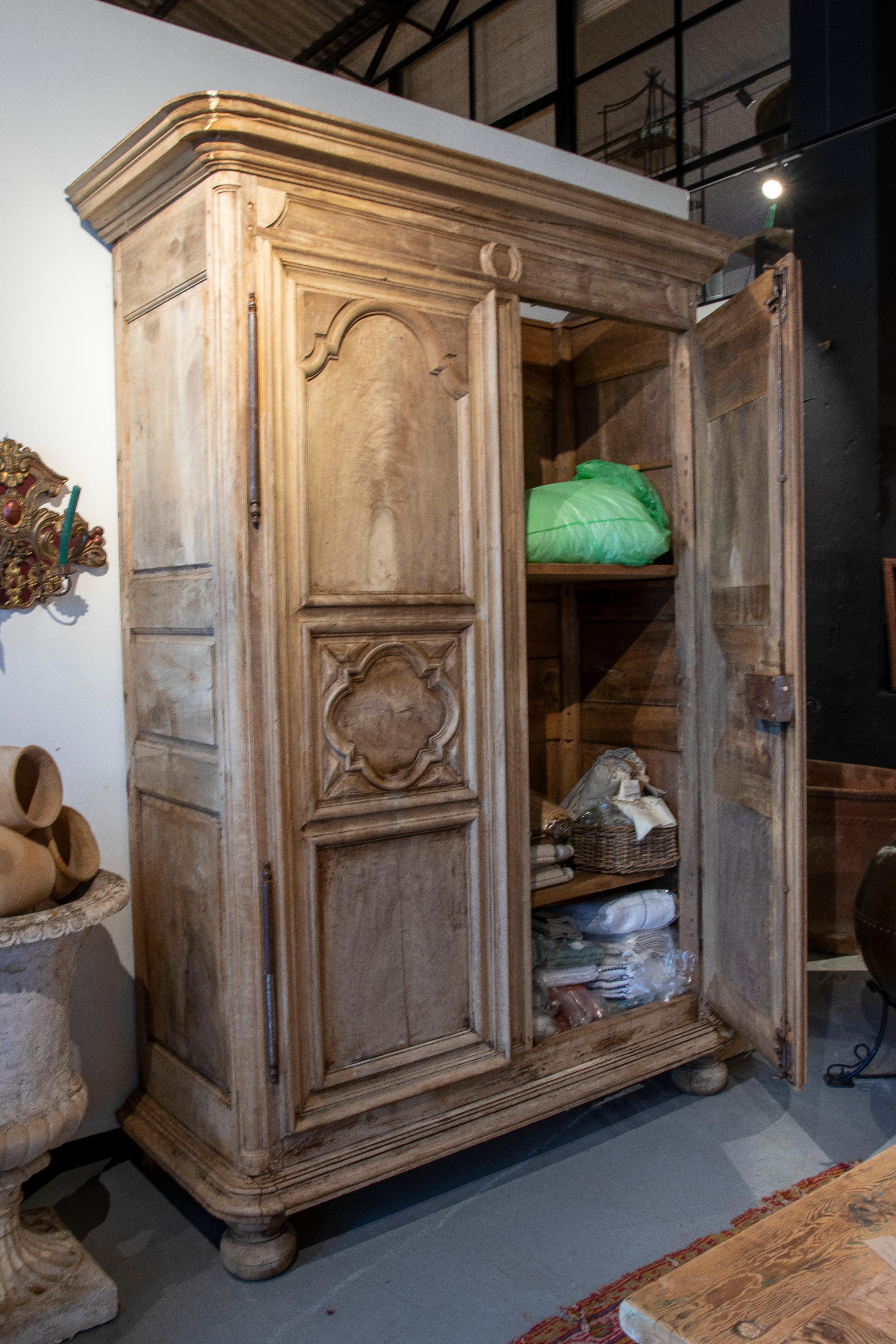 18th Century French hand-carved walnut wardrobe with two doors.