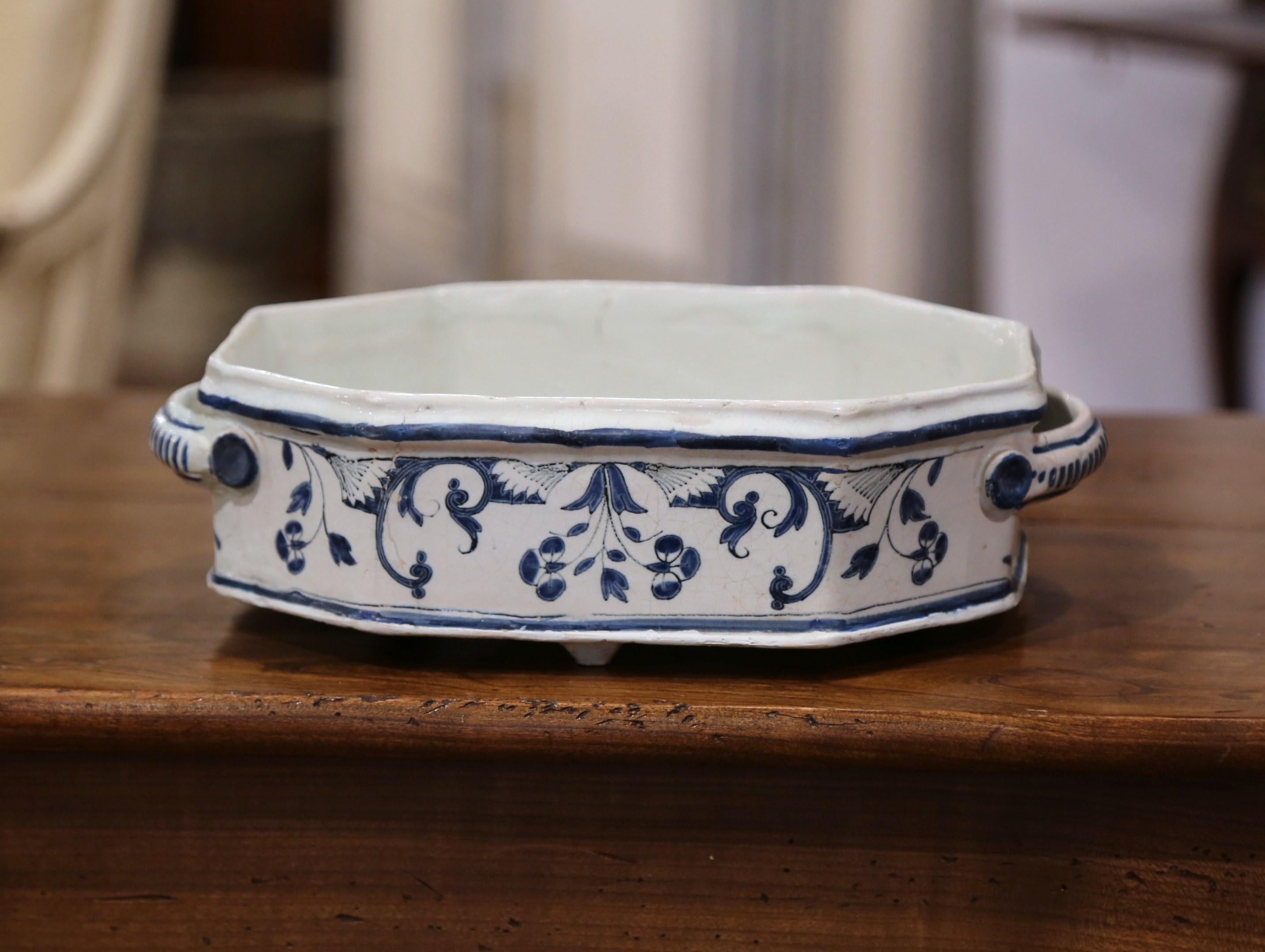 This elegant, octagonal planter was crafted in northern France, circa 1780. The traditional, antique, ceramic jardiniere has handles and features hand painted flower motifs in a Classic blue and white palette. The piece is in excellent condition