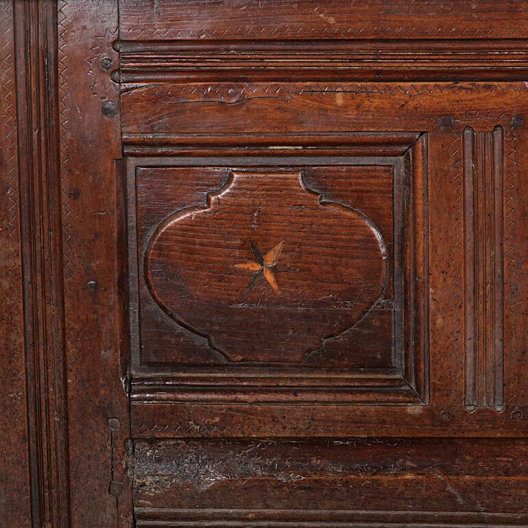 Large French chestnut and oak paneled coffer with inlaid ebony and boxwood stars to each shaped panel. Generous storage under hinged top. Very sturdy and an excellent height for using as a bench in a foyer / mudroom etc.


  