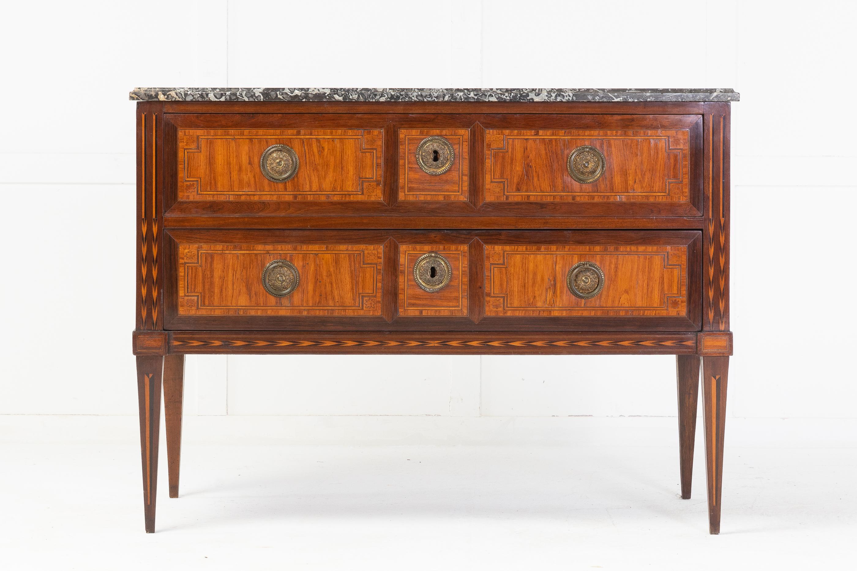 18th century French king wood and tulip wood commode. A very good proportioned and nicely balanced inlaid commode with original medallion handles. Having marquetry inlay and nice marble top. Standing on inlaid and tapering legs.
 