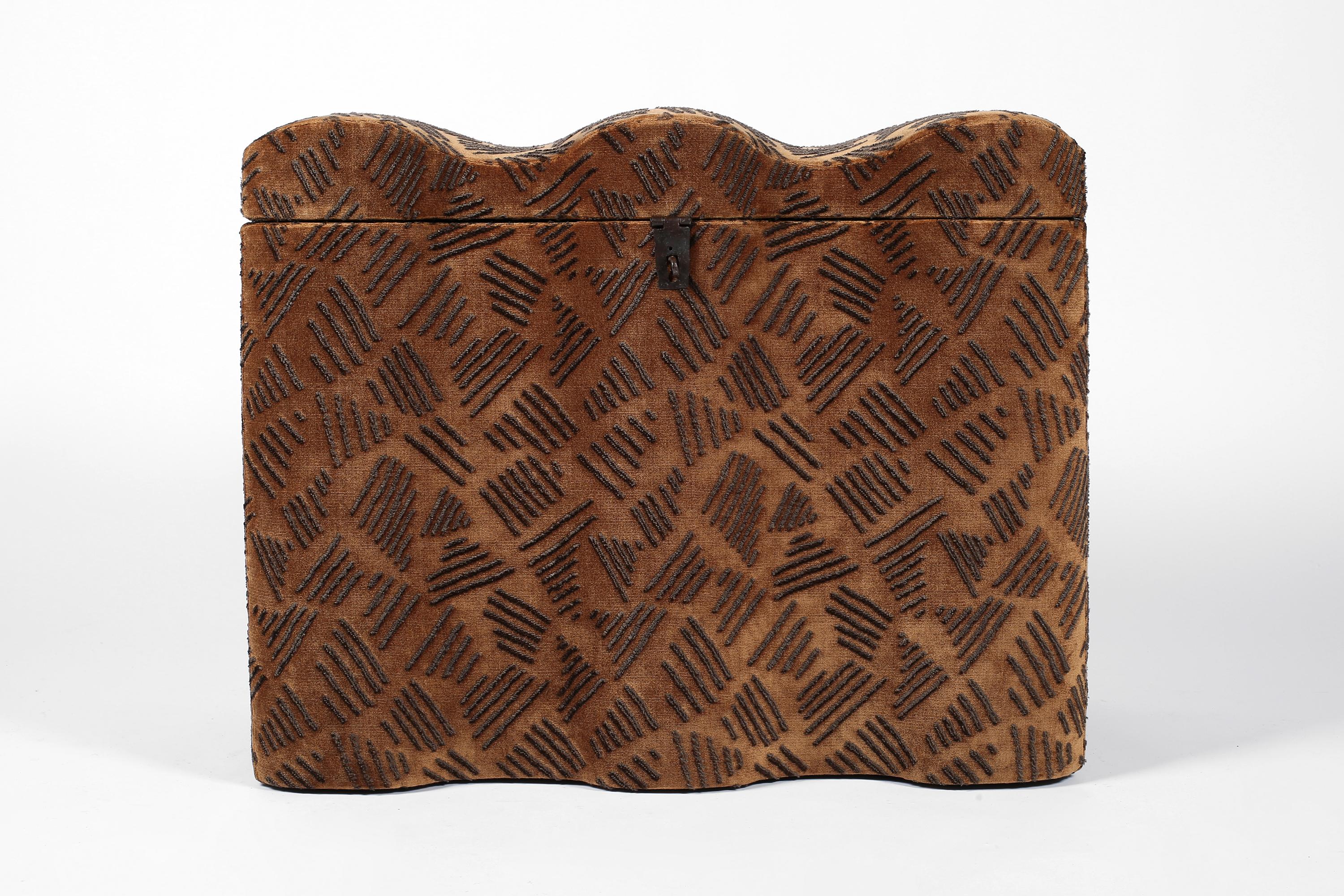 An atypical 18th century pine chest of moulded, serpentine form with forged iron hardware. Upholstered in ‘Kuba’ by Larsen - a tobacco hued velvet, boldly influenced by African textiles. French, c. 1750.