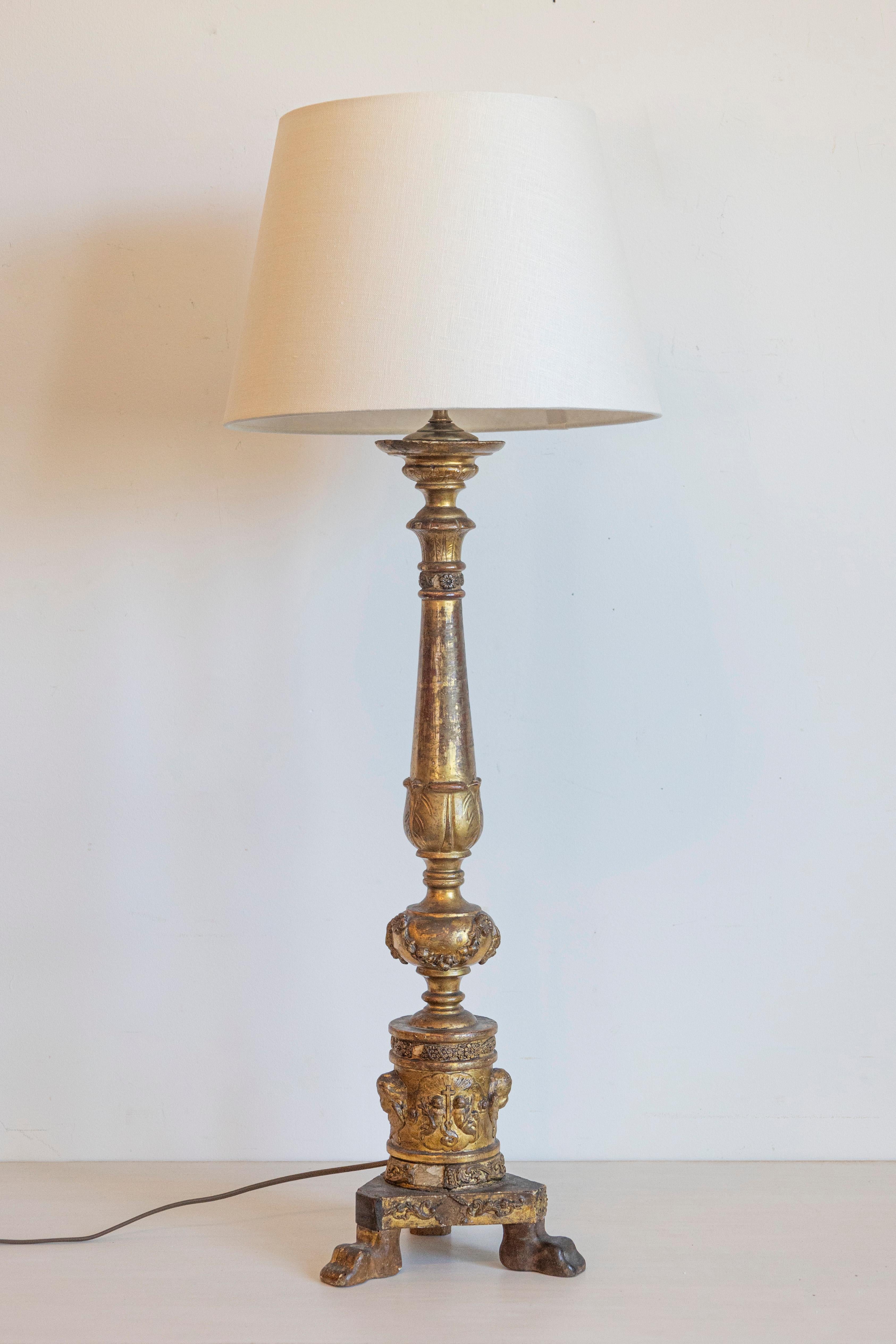 Cette lampe de table remarquable est une adaptation étonnante d'un chandelier en bois doré du XVIIIe siècle, transformé avec brio pour un éclairage moderne. Riche en influences néoclassiques, la pièce présente une colonne gracieusement effilée,