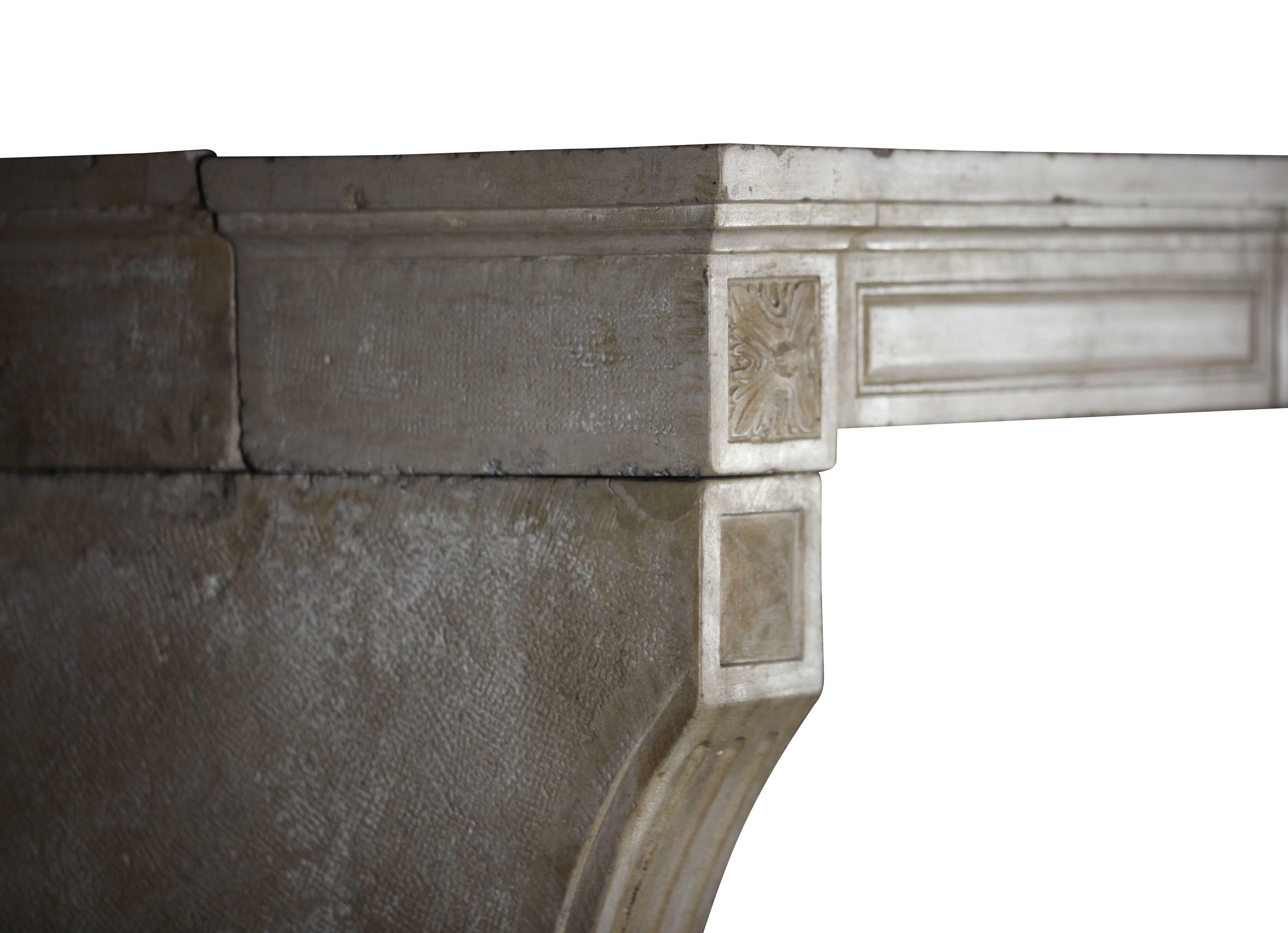 This nice original antique fireplace surround in limestone with fruit detail in the center and diamond point detail on the legs is unique. Five solid blocks. There are some remains of the original patina. The ancient surfaces has a glossy