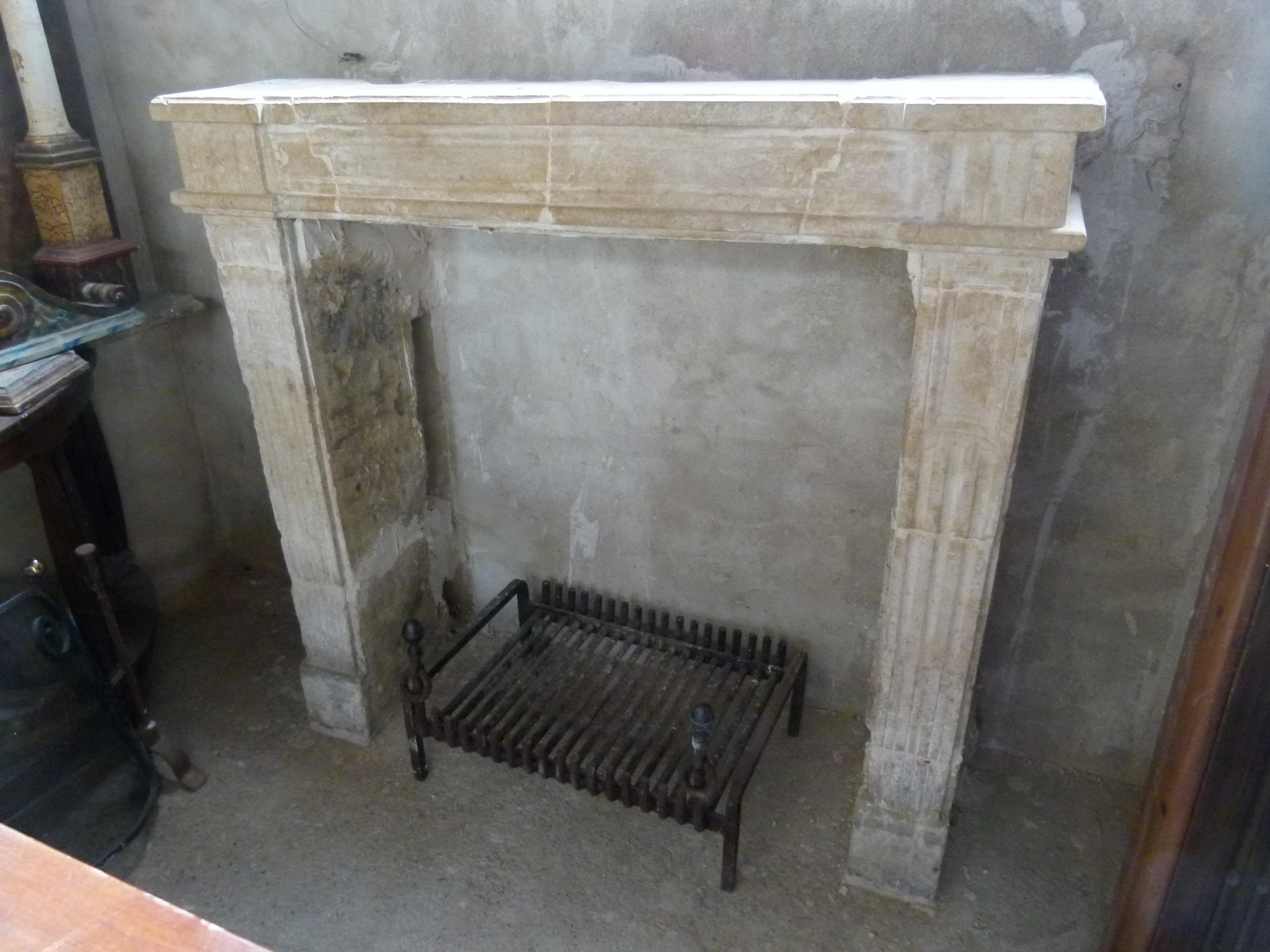 Antique 18th century in Louis XIV style French limestone carved fireplace mantel.