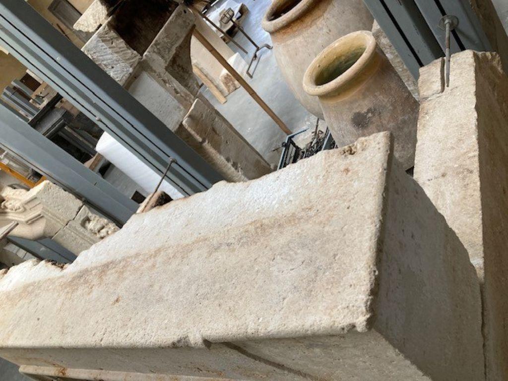 Carved 18th Century French Limestone Fireplace Mantel For Sale