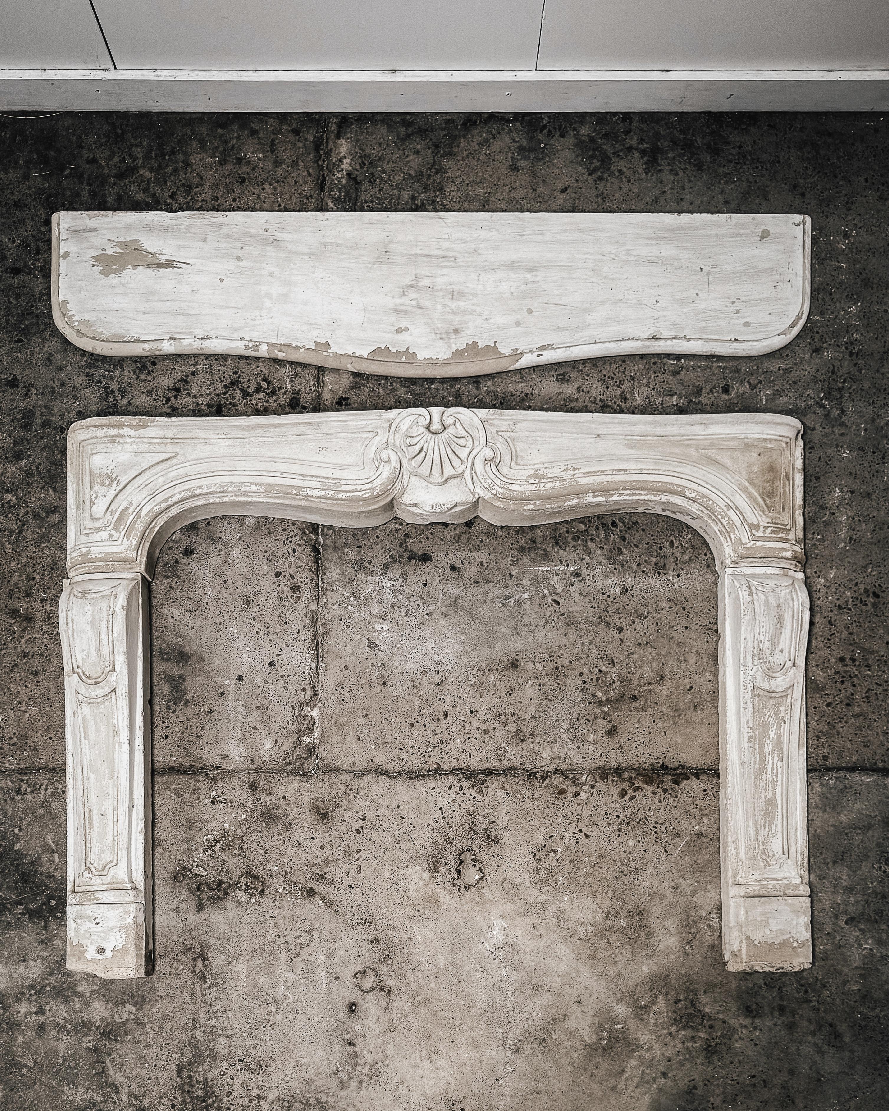 Salvaged from a countryside chateau in northern France, this fireplace mantel exudes classic French style reminiscent of the Louis XV era. Crafted from limestone and dating to the late 18th century, it showcases intricate hand-carved architectural
