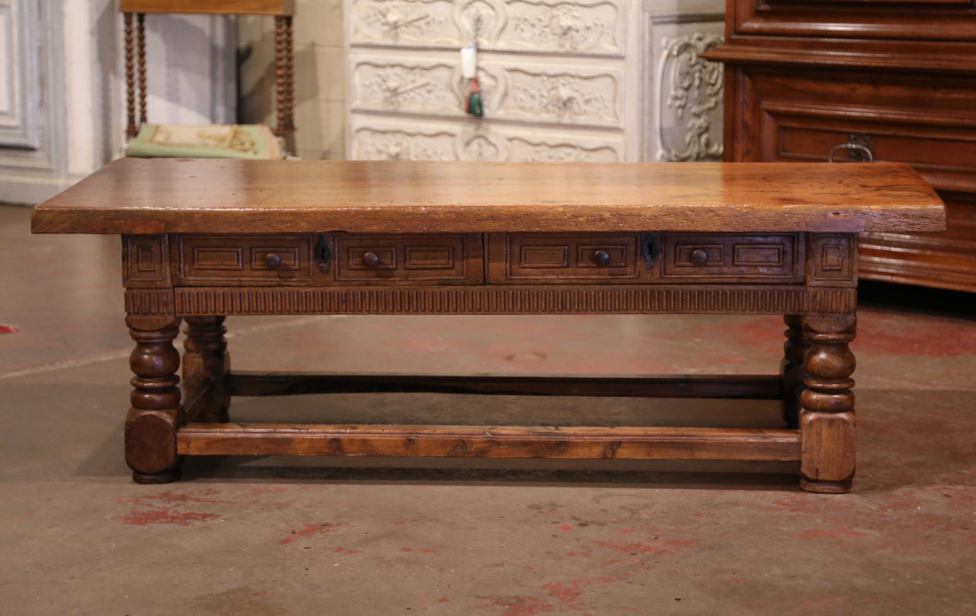 This elegant and large antique cut down table was crafted in Southern France, circa 1780. Standing on thick turned legs embellished with a decorative rectangular stretcher at the base, the large cocktail table features a top made of one single