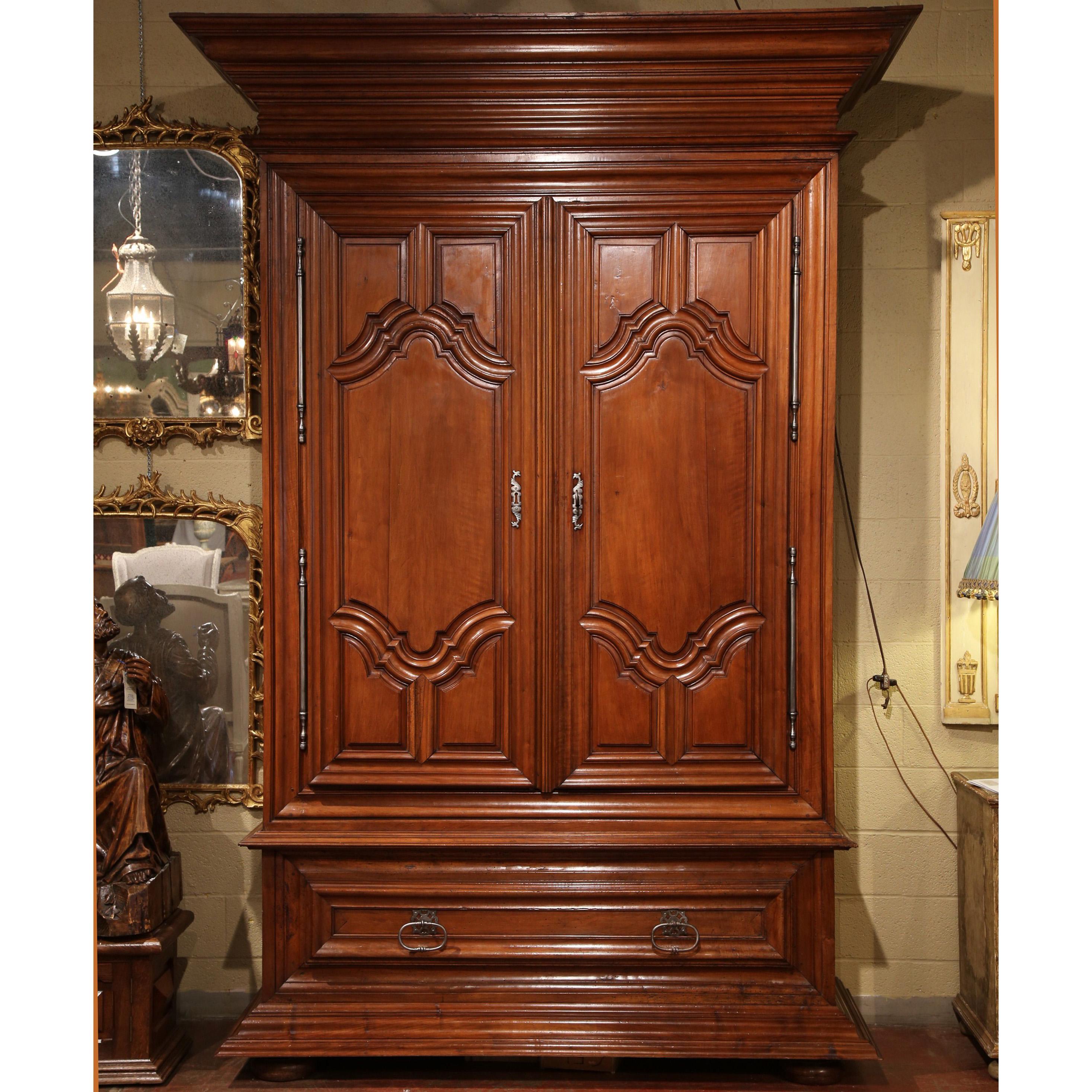 This grand, monumental armoire is derived from the chateaux region of the Loire Valley of France. The region includes notable palaces including Chamborg, Chenonceau, Chevergny, Azay le Rideau, etc. Carved, circa 1760, this fruitwood wardrobe is huge