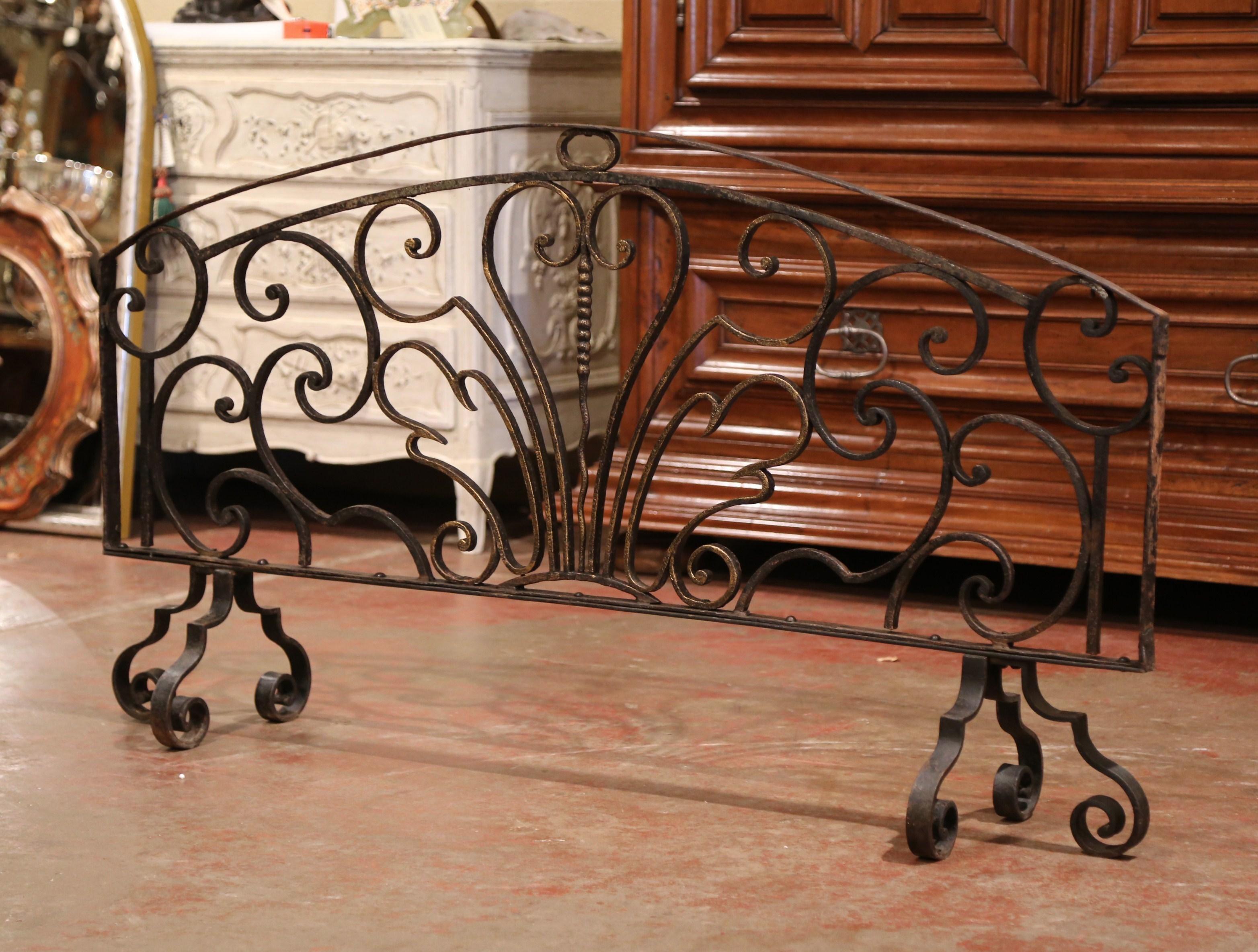 Decorate a fireplace hearth with this impressive freestanding antique iron screen. Forged in France circa 1760, the important wrought iron screen with arched top stands on six scrolled feet and features decorative scroll work throughout. The