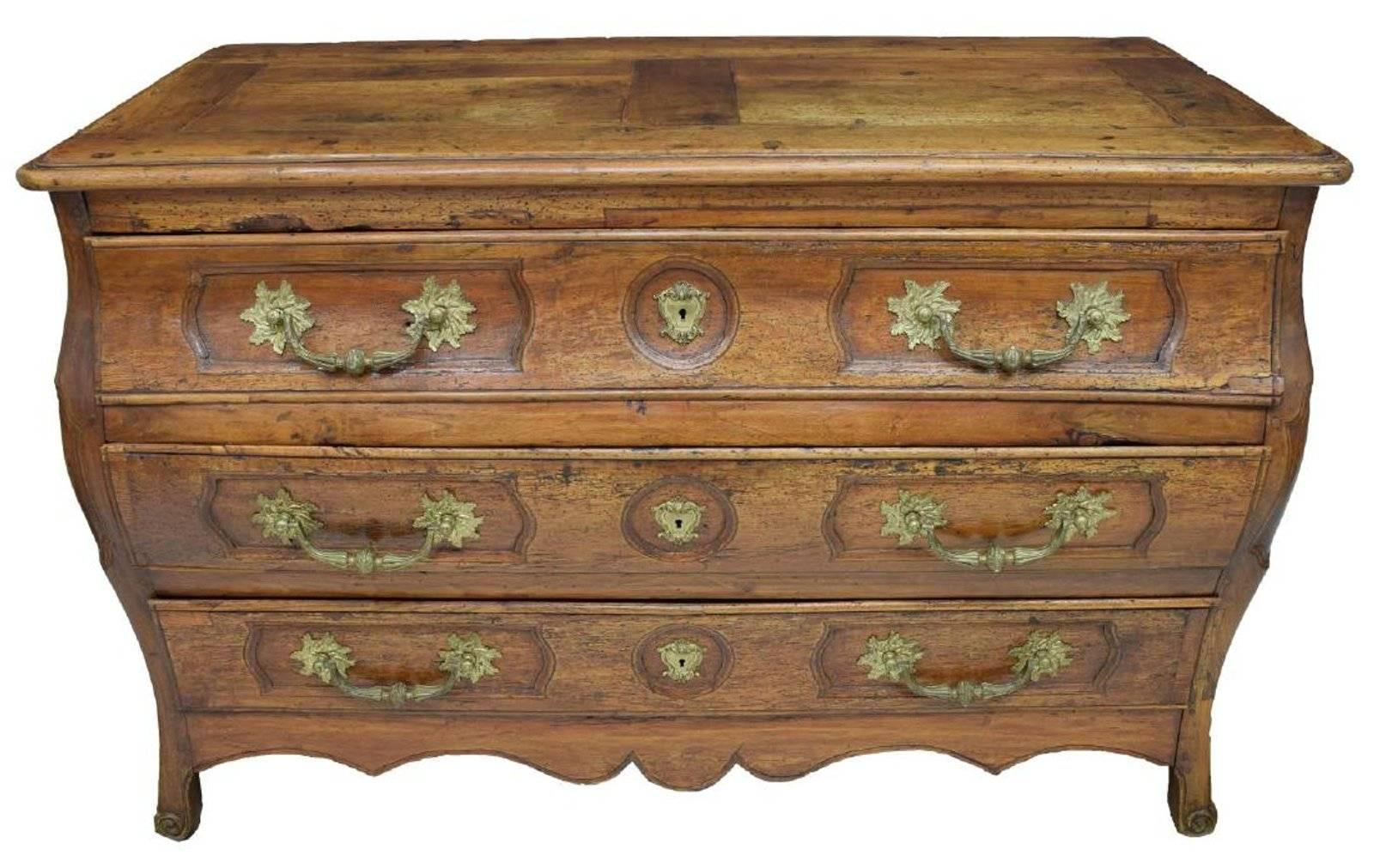 Beautiful 18th century French Louis XIV bombe chest with paneled top over three drawers rising on scroll foot legs. Wear consistent with age.
