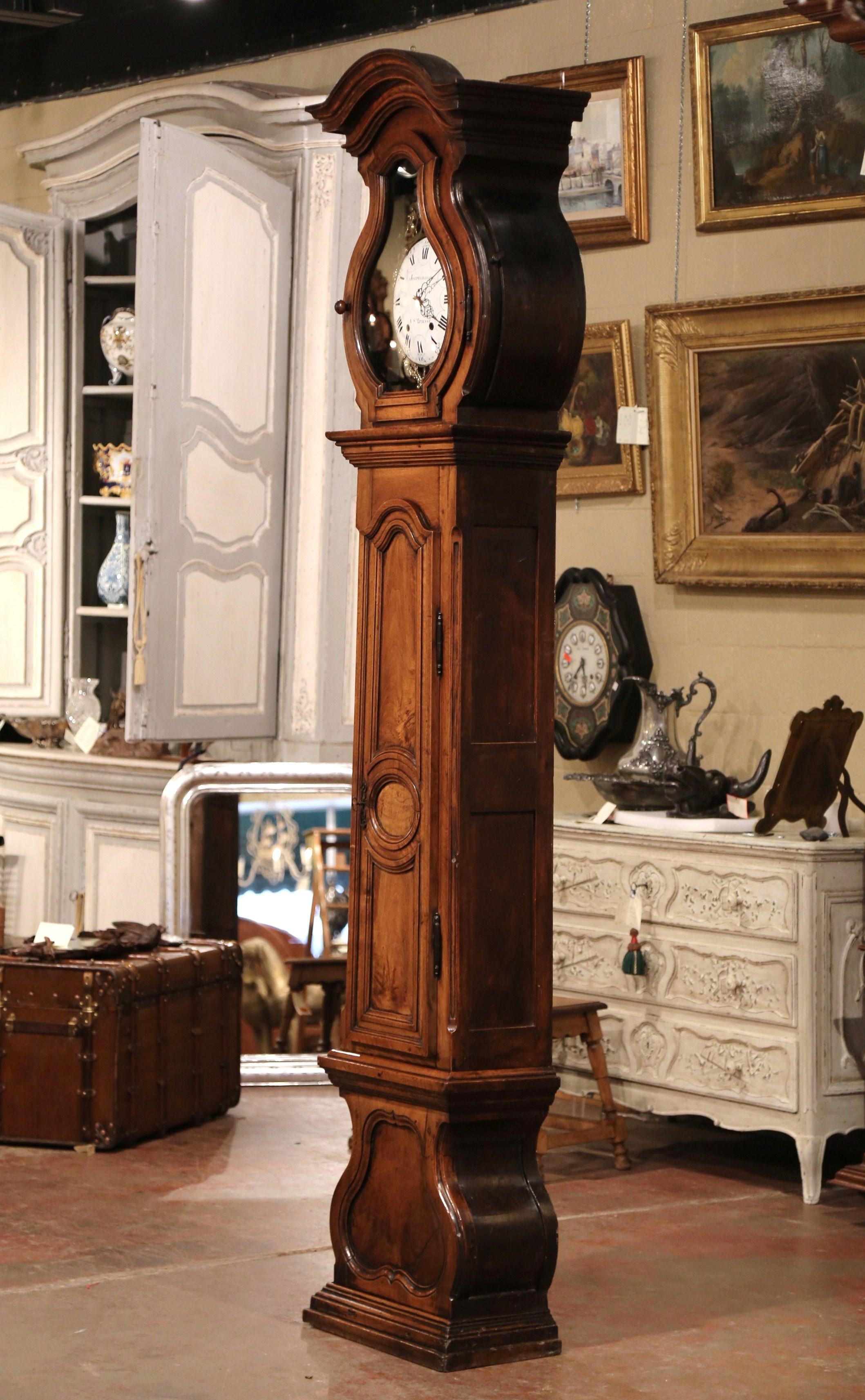 This elegant, antique long case clock was crafted in Lyon, France, circa 1760. The fruitwood grandfather clock built in three sections has beautiful lines including an elegant bonnet top at the pediment, a long center door with raised panel, and a