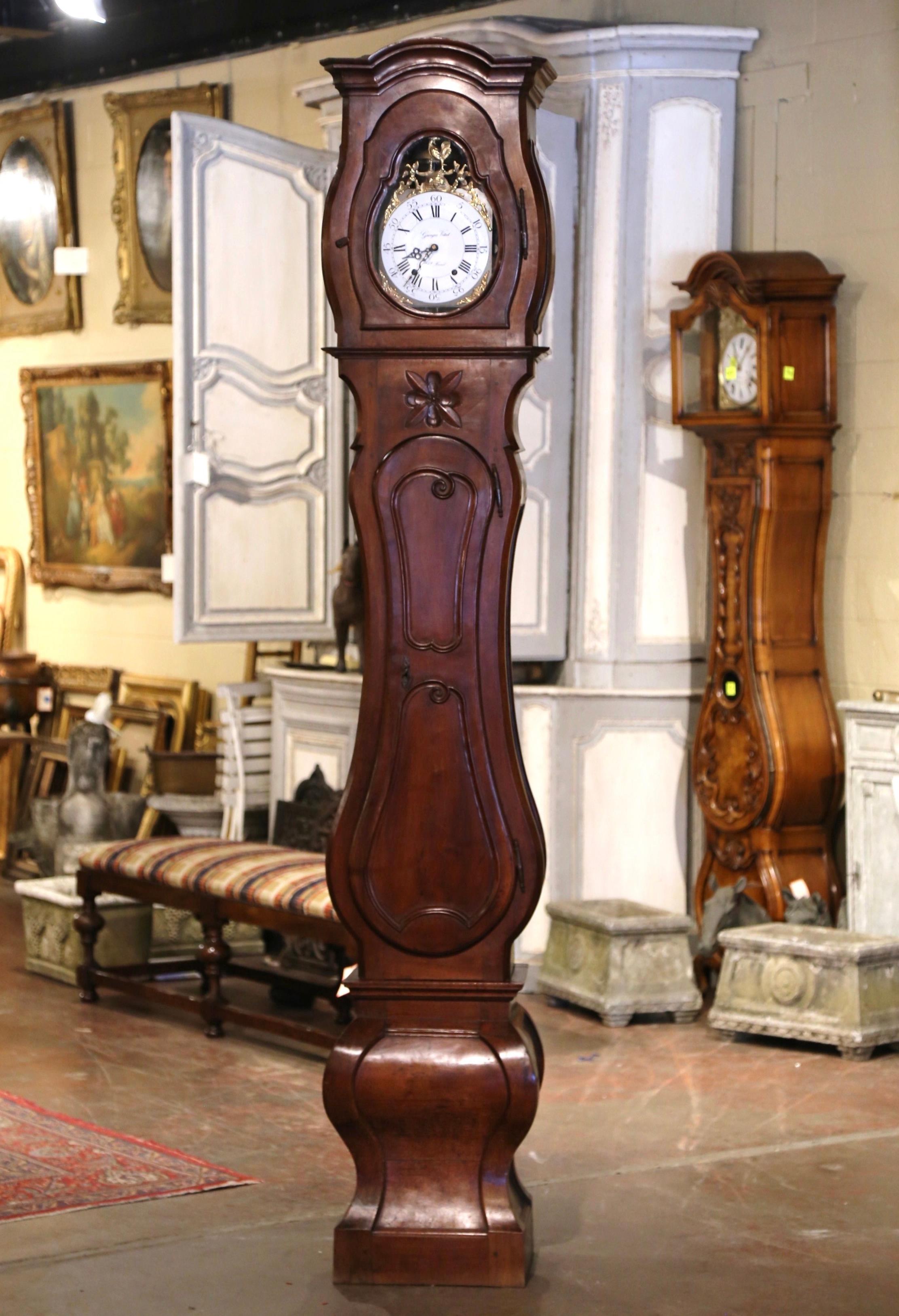 This elegant, antique long case clock was crafted in Lyon, France, circa 1780. The fruitwood grandfather clock built in two sections has beautiful lines including an elegant bonnet top at the pediment, a long center door with raised panel and