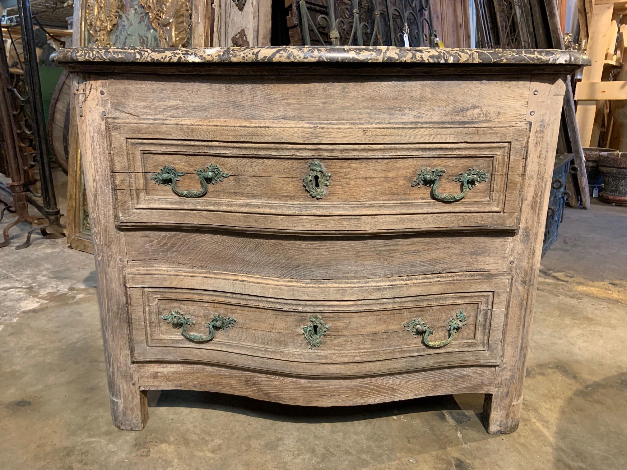 A very handsome 18th century French Louis XIV style commode soundly constructed from washed oak with its original marble. Wonderful color. Perfect as a bedside cabinet or for any living area.