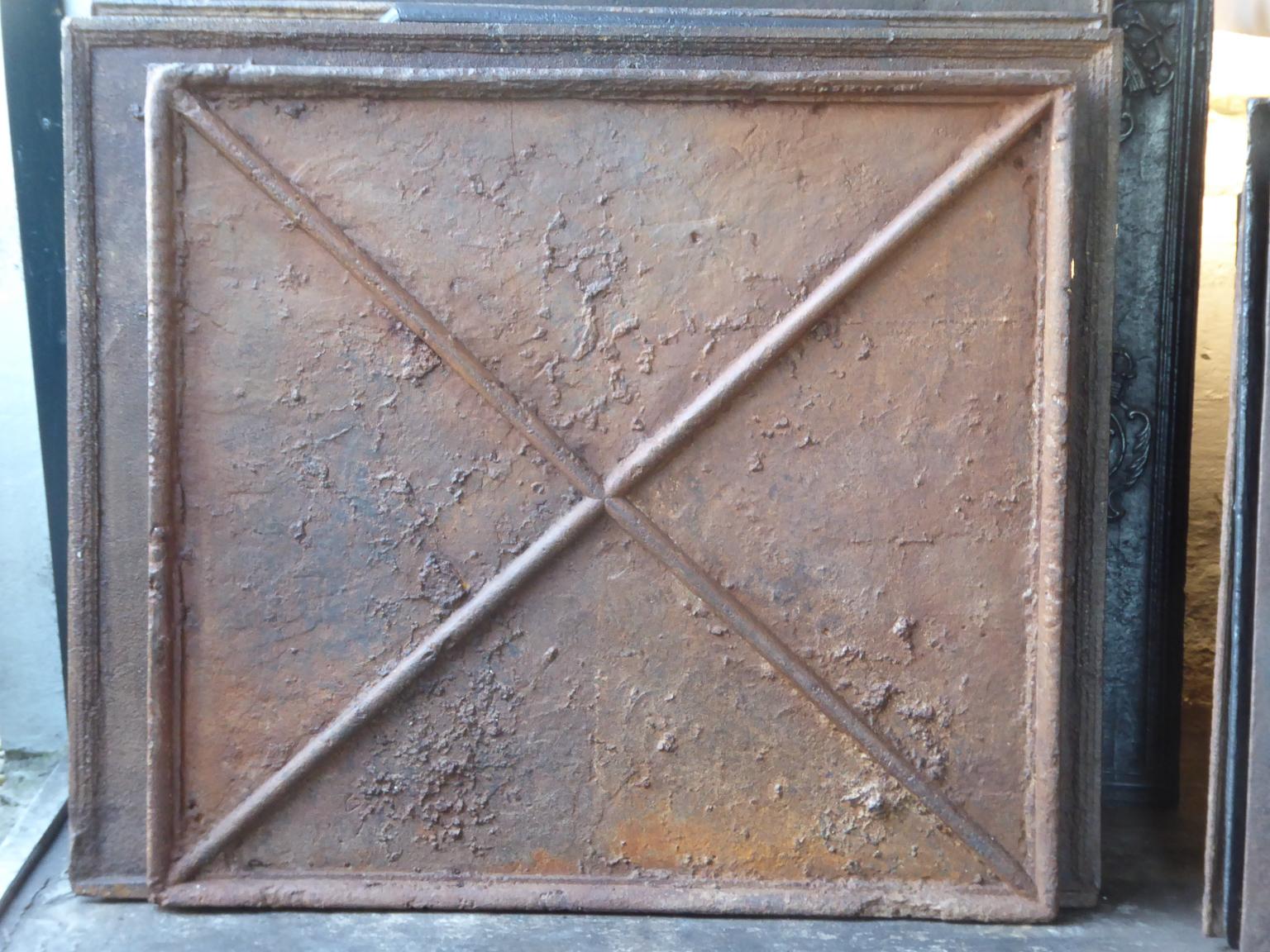 Beautiful 18th century French fireback with a Saint Andrew's cross. Saint Andrew is said to have been martyred on a cross in this shape. The cross is since then a sign for humility and sacrifice. The patina of the fireback is a natural brown, which