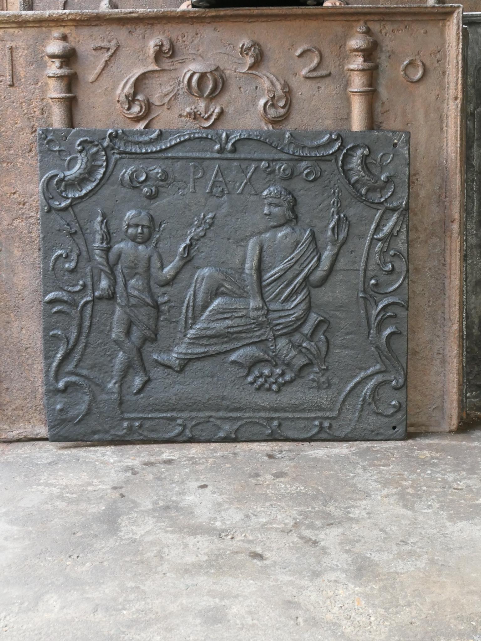 18th Century French Louis XV fireback with an Allegory of Peace. The Allegory of Peace is holding an olive branche, symbol for peace, and a laurel wreath, symbol for victory, in her hands. The fireback is made of cast iron and has a black / pewter