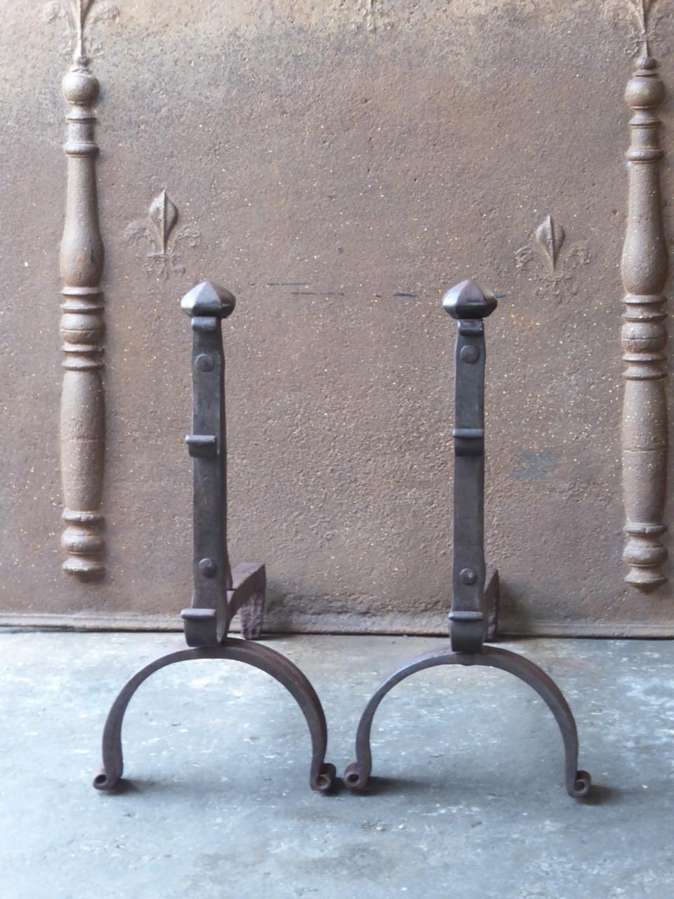 18th century French Louis XV andirons made of wrought iron. The andirons have spit hooks to grill food.

We have a unique and specialized collection of antique and used fireplace accessories consisting of more than 1000 listings at 1stdibs. Amongst