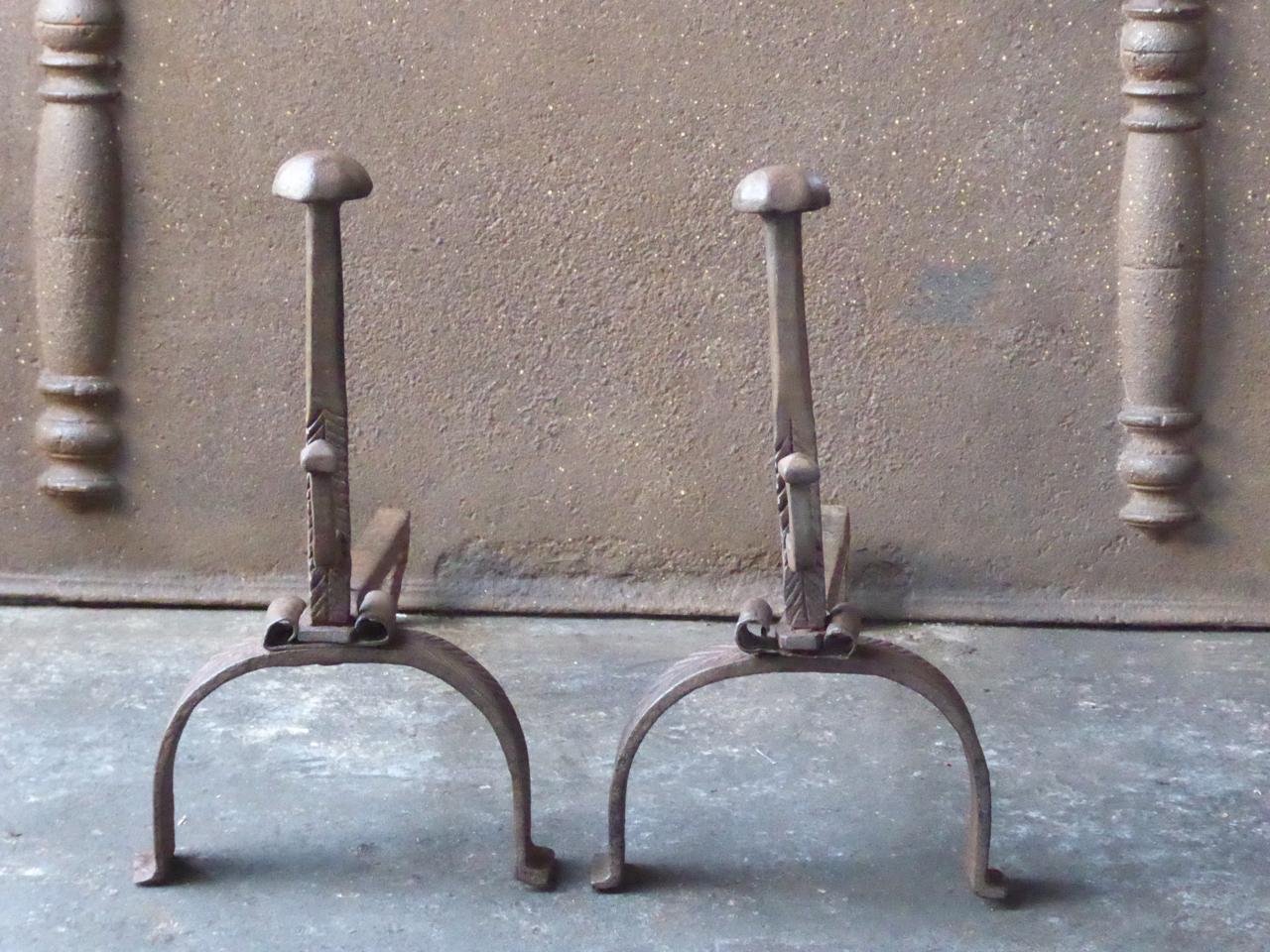 18th century French Louis XV andirons. The andirons are made of wrought iron and are beautifully forged and carved. They have spit hooks to grill food. The condition is good.







    