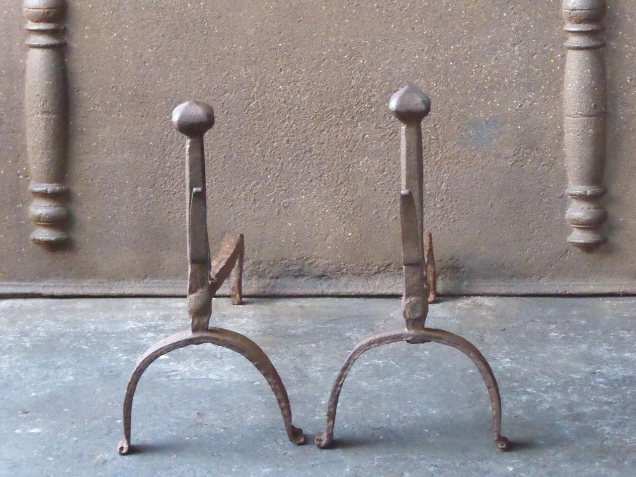 18th century French Louis XV andirons. The andirons are made of wrought iron and are beautifully forged and carved. They have spit hooks to grill food. The condition is good.







 