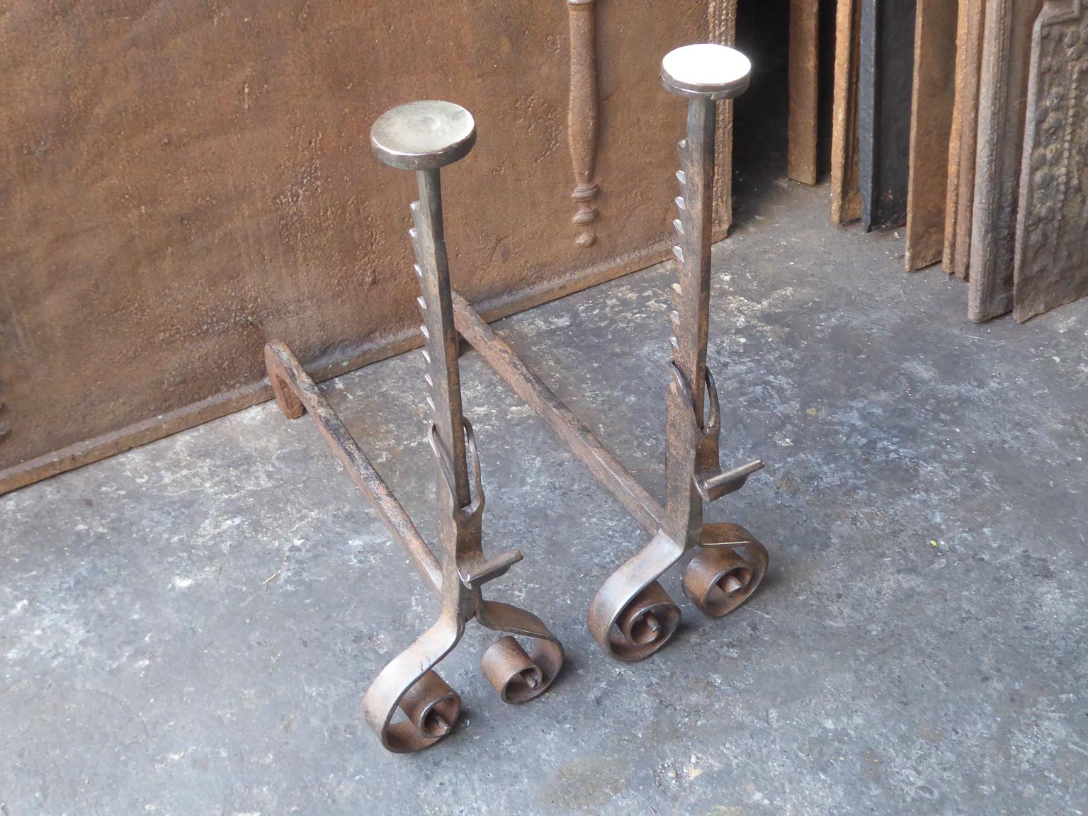 18th century Louis XV Iron andirons made of wrought iron. The andirons have spit hooks to grill food. The height of the spit hooks can be regulated. The condition is good.







 