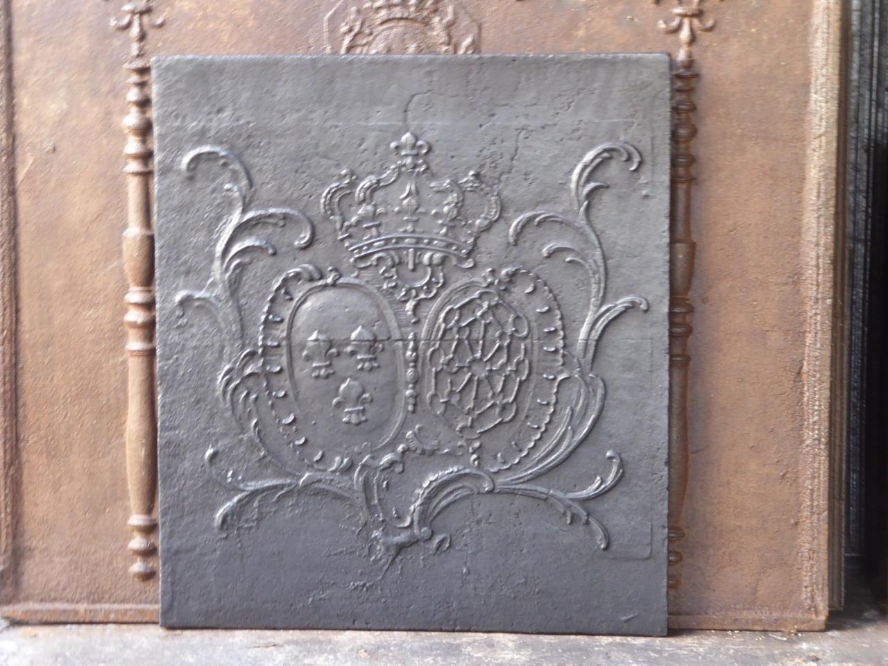18th century French Louis XV fireback with the arms of France and the arms of Navarre combined. The arms of France are the arms of the House of Bourbon. This is one of the major royal dynasties of Europe that produced monarchs of Spain (Navarre),