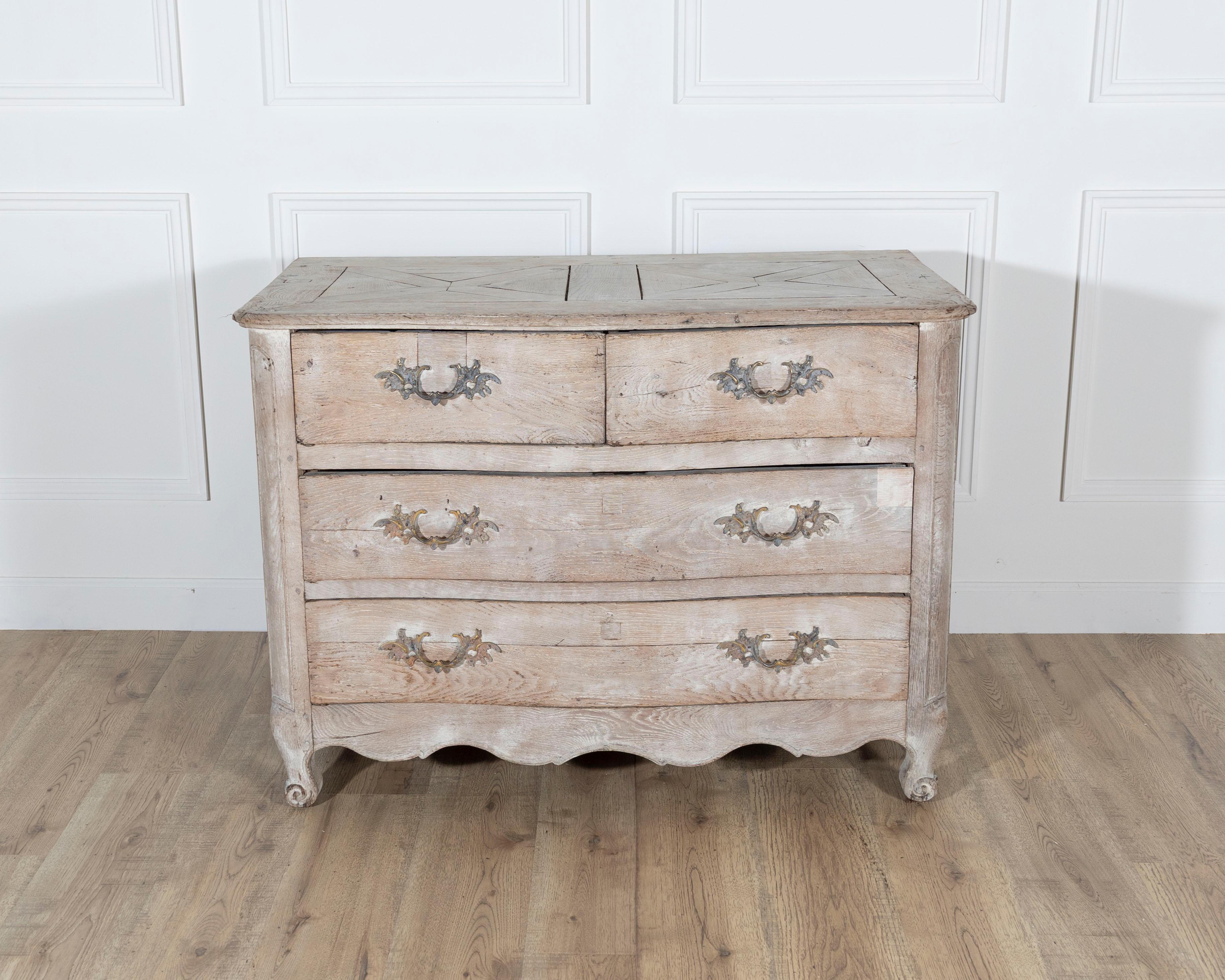 18th Century French Louis XV Bleached Oak Curved Commode with Parquet Top

A graceful example of 18th-century French craftsmanship, this Louis XV period commode showcases the timeless allure of bleached oak. The gently curved façade and scalloped