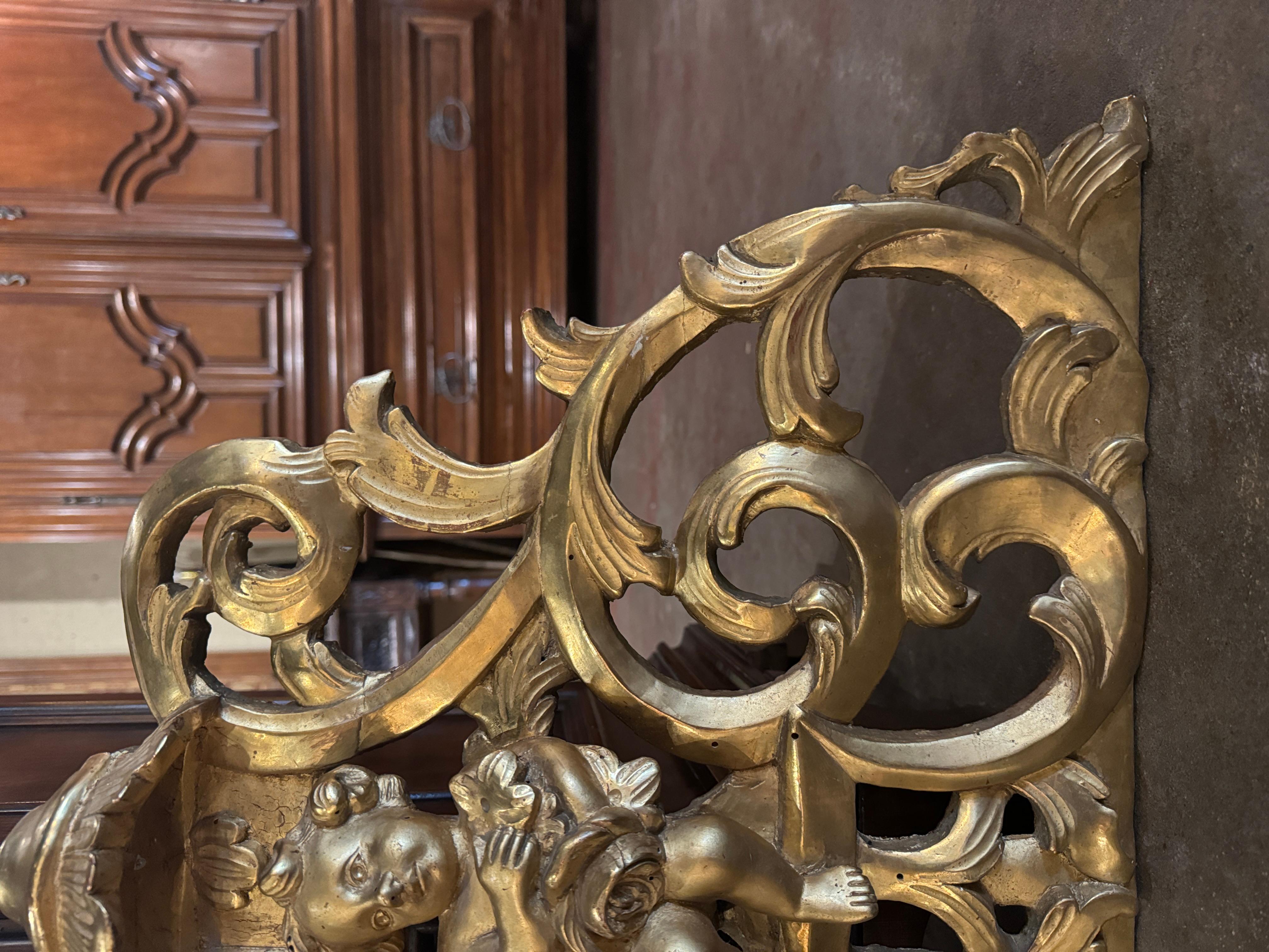 Hand-Carved 18th Century French Louis XV Carved and Pierced Giltwood Wall Decor with Cherub For Sale