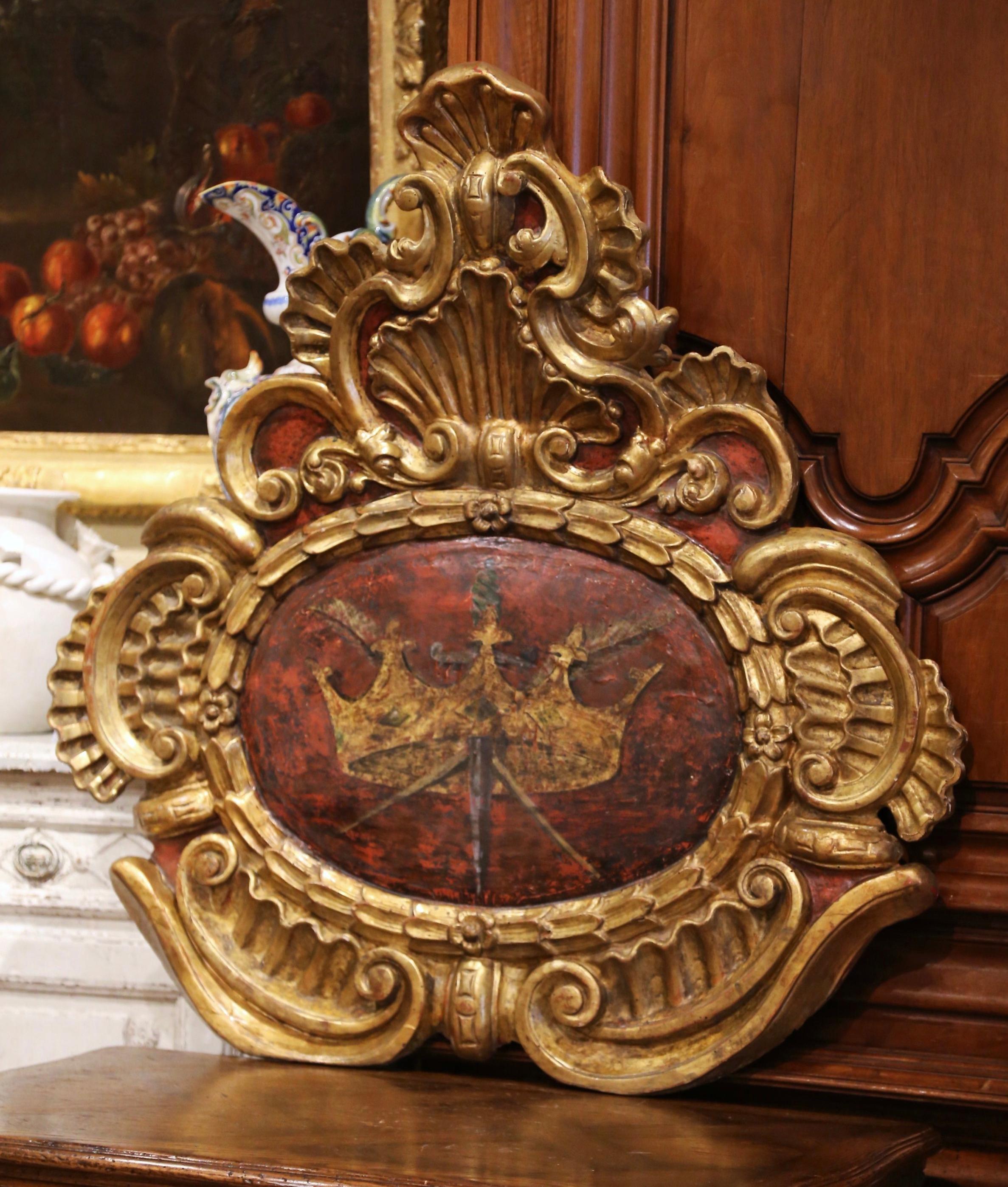 Embellish a mantel or decorate a man's office with this important antique wood carved sculpture. Crafted in France, circa 1780, the elegant wall-mounted plaque features exquisite carved scrolled including a large shell motif at the pediment. The