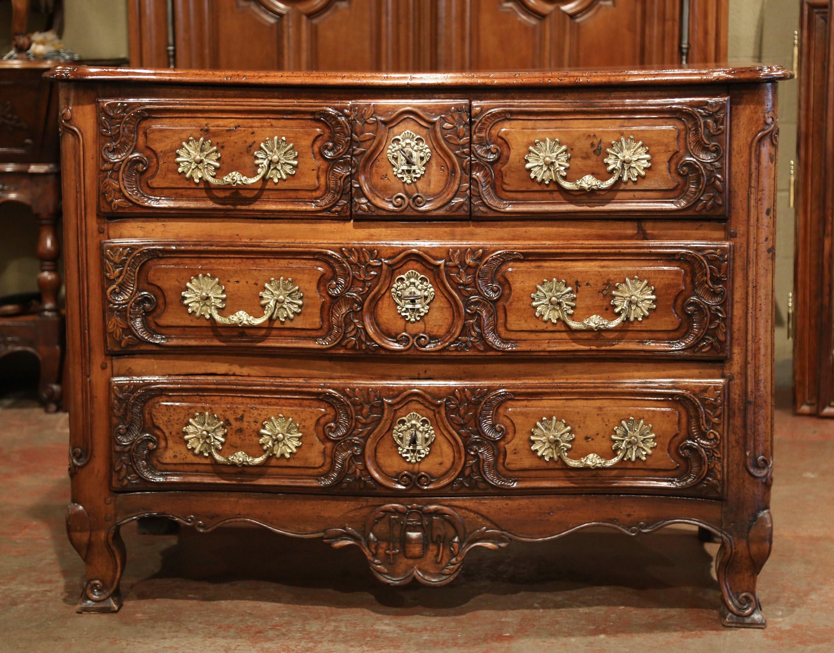 Decorate an entry or a bedroom with this large, antique serpentine commode Lyonnaise; carved in France, circa 1760, the elegant, fruitwood cabinet stands on scrolled feet over a scalloped apron with a decorative shell motif; it features three