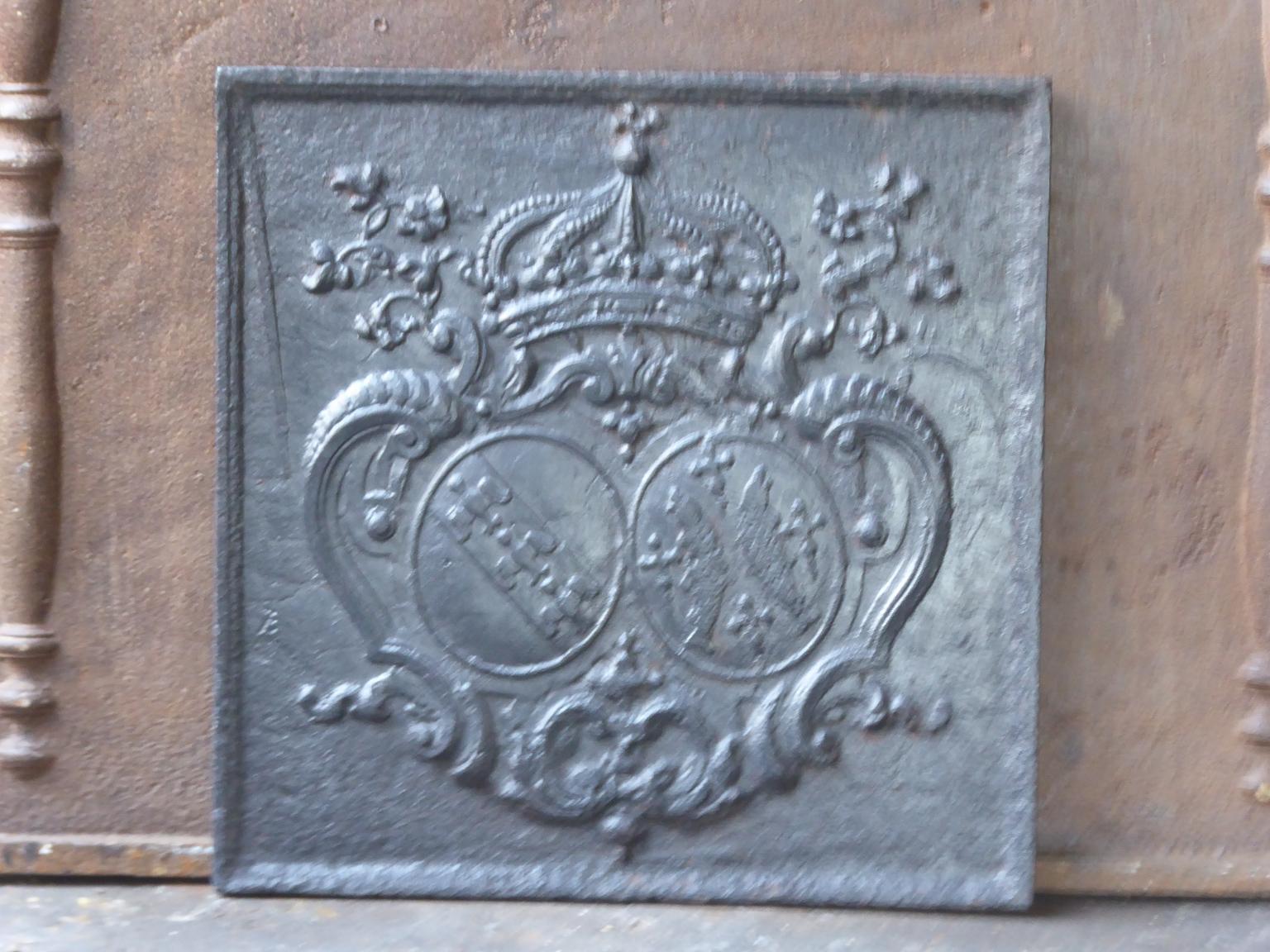18th century French Louis XV fireback with a coat of arms. The fireback is made of cast iron and has a pewter / black color. The fireback is in a good condition and has no cracks.








