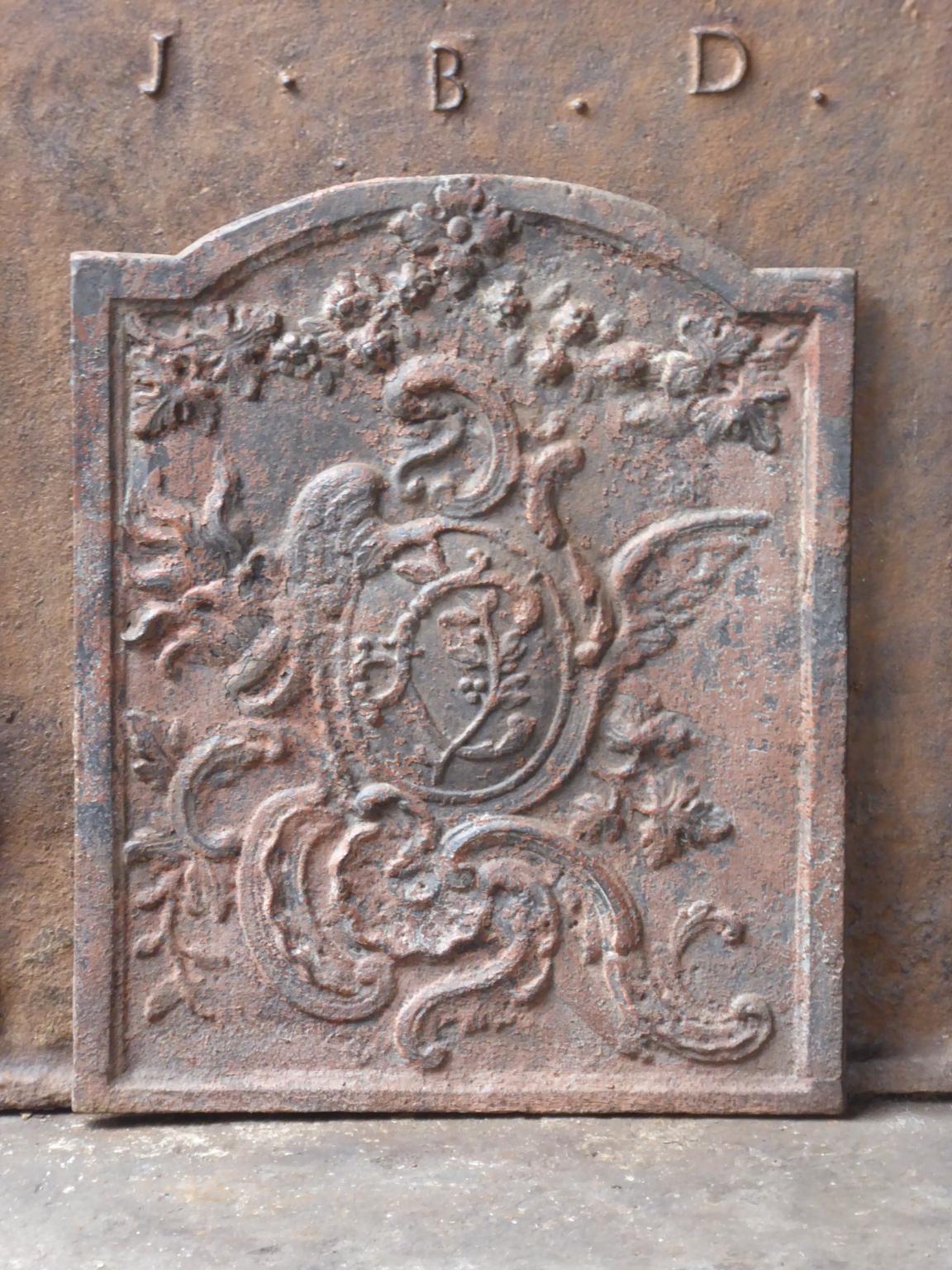 18th century French Louis XV fireback with a typical Louis XV decoration.

The fireback is made of cast iron and has a natural brown patina. Upon request it can be made black / pewter. The fireback is in a good condition and does not have