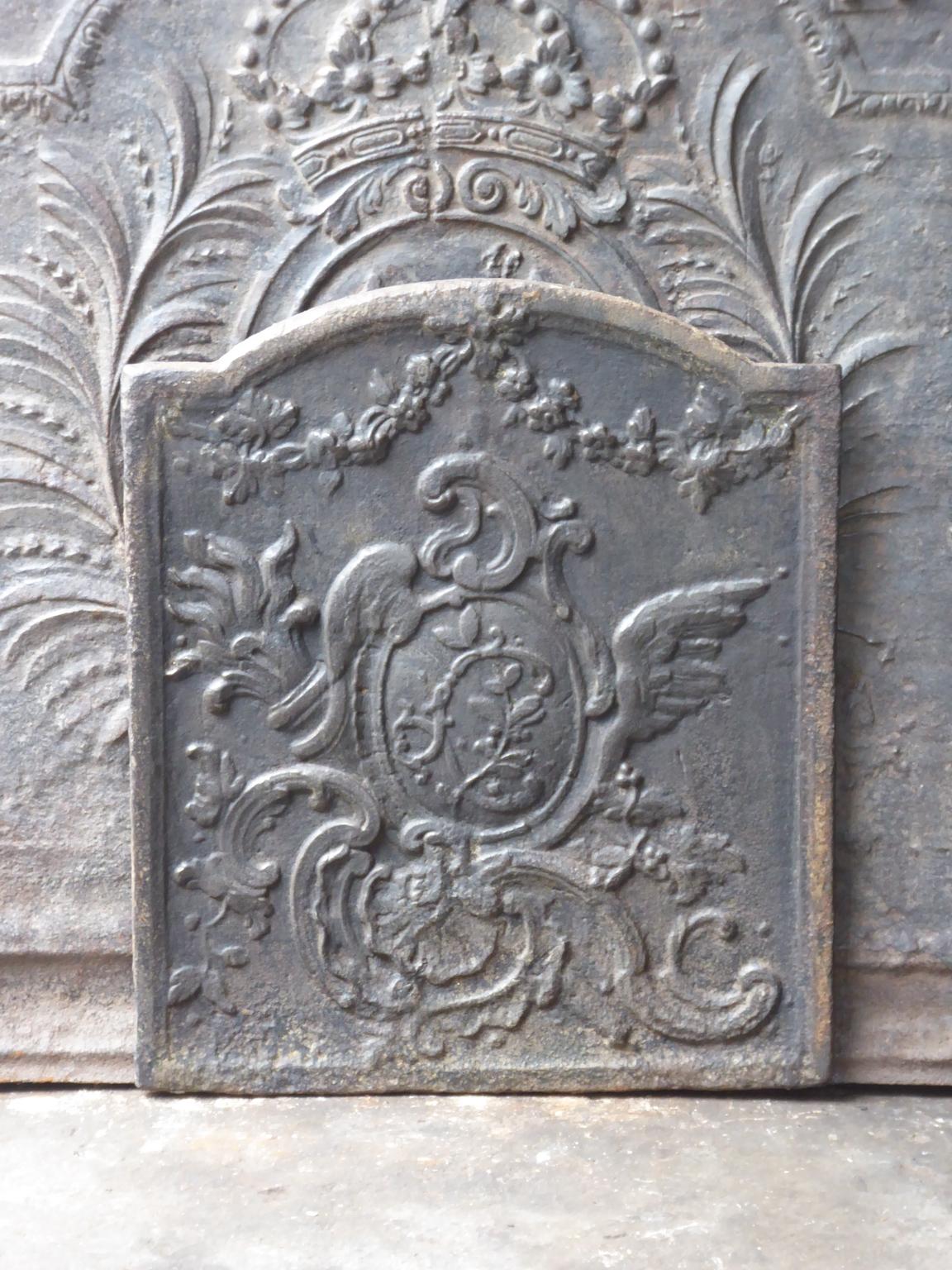 18th century French Louis XV fireback with a typical Louis XV decoration.

The fireback is made of cast iron and has a natural brown patina. Upon request it can be made black / pewter. The fireback is in a good condition and does not have