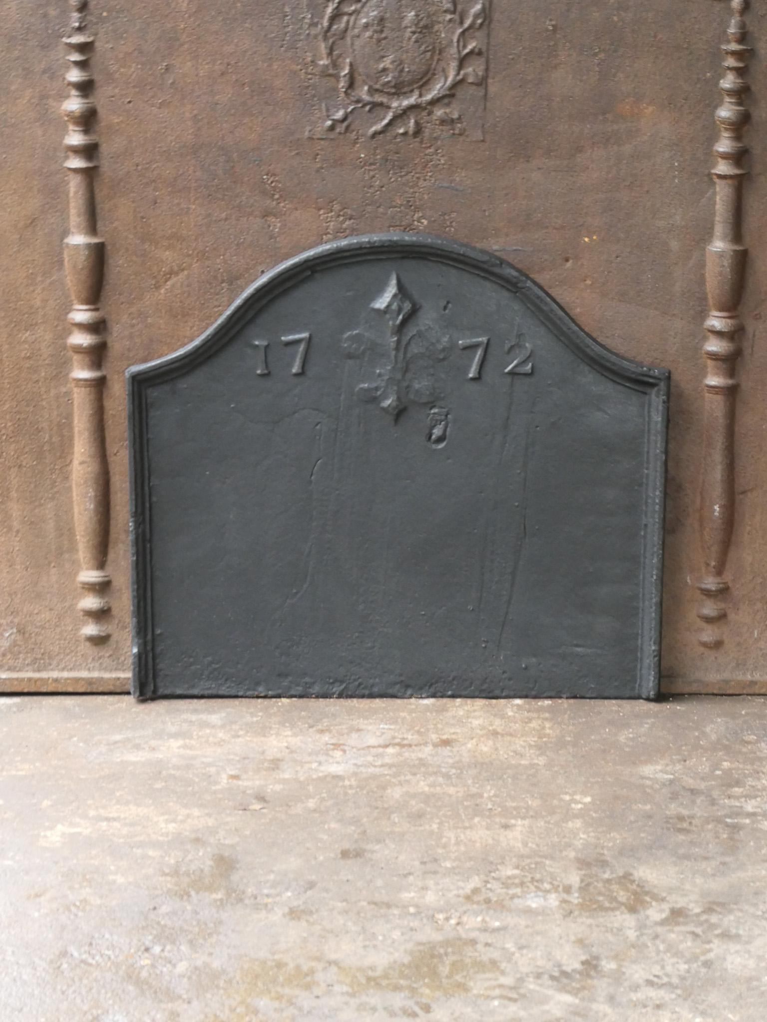 Beautiful 18th century French Louis XV fireback with Fleur de Lys (French Lily). The Fleur de Lys symbolized royalty and aristocracy throughout Europe.  During the French revolution the Fleur de Lys was partially truncated as it symbolized loyalty