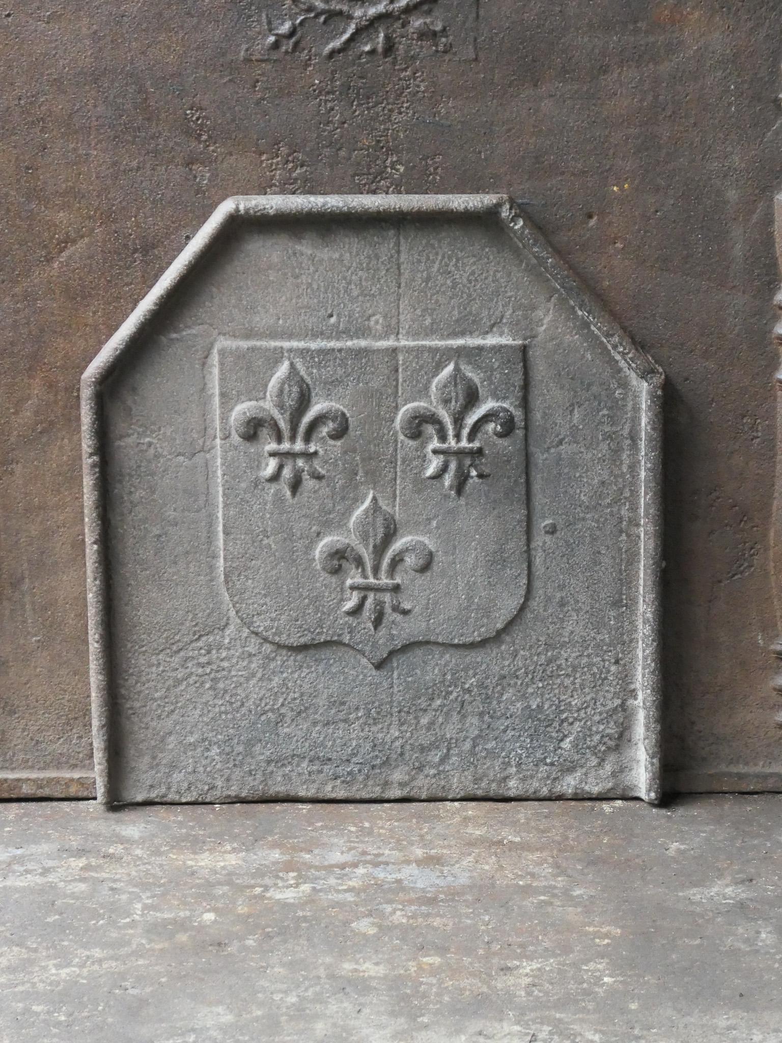 Beautiful 18th century French Louis XV fireback with three Fleurs de Lys. The Fleur de Lys (French Lily) symbolized royalty and aristocracy throughout Europe. 

The fireback has a natural brown patina. Upon request it can be made black / pewter