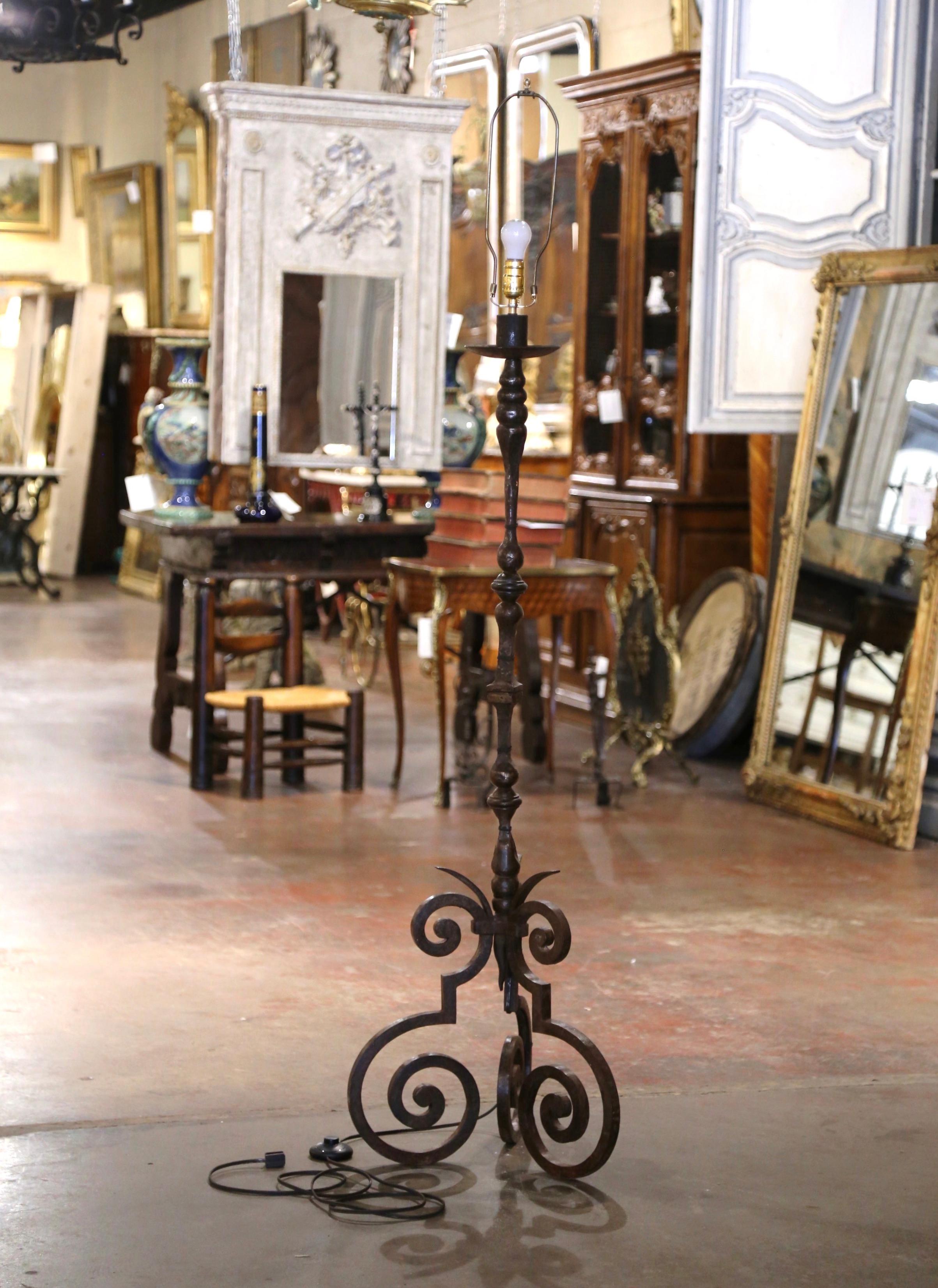 Decorate a study of office with this robust antique iron floor fixture.  Forged in southern France, circa 1780, the  wrought iron lamp base exemplifies the craftsmanship and artistic flair of the period. The fixture stands on three intricate