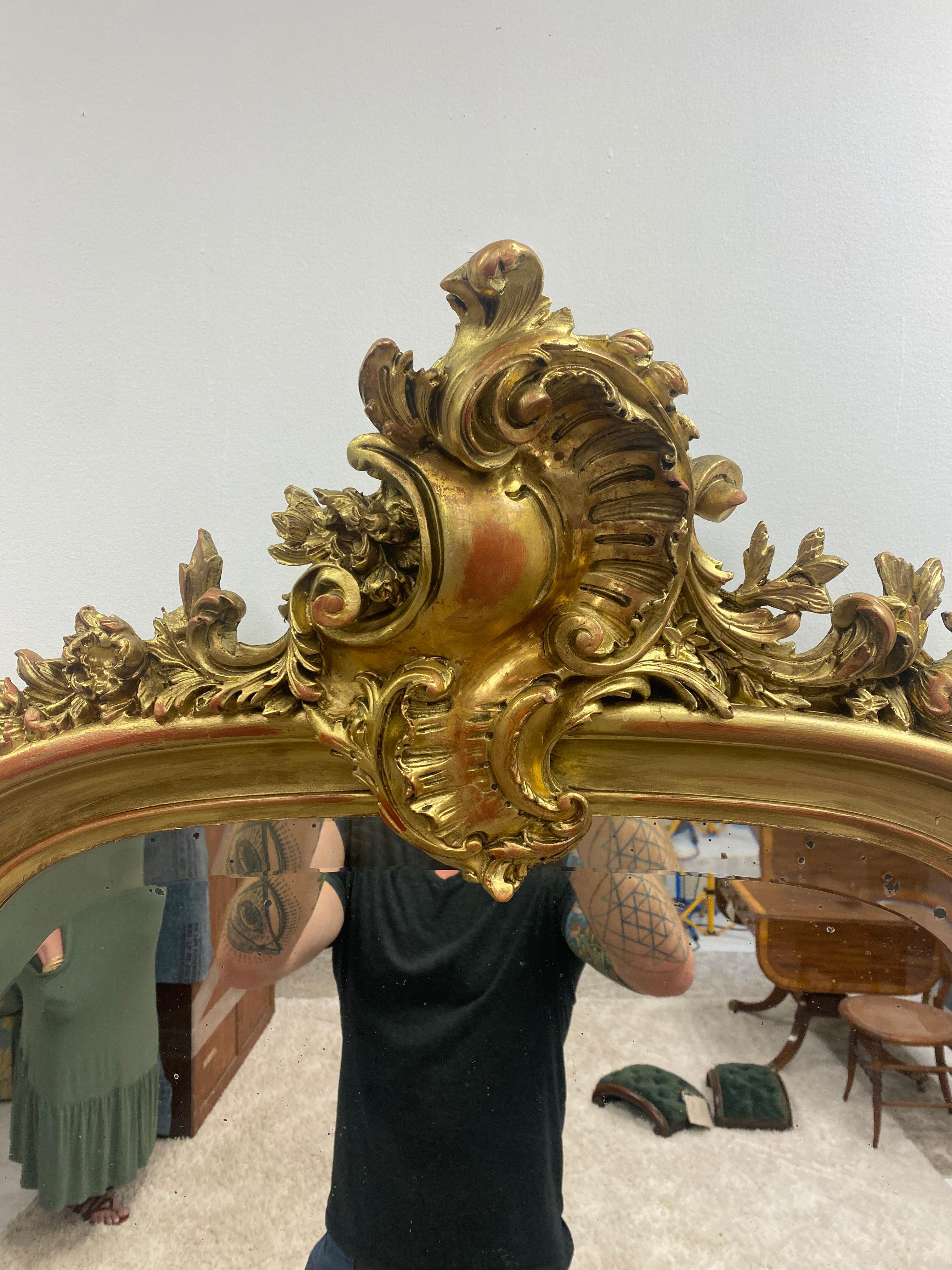 Finely carved French Louis XV gilt wood mirror. Decorated with Rocaille motif throughout. 18th century, (France Circa 1723-1774) 
Original hand beveled glass. This item was carefully restored and is ready for service. 

 