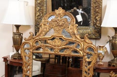18th Century French Louis XV Giltwood Mirror with Floral Basket Crest