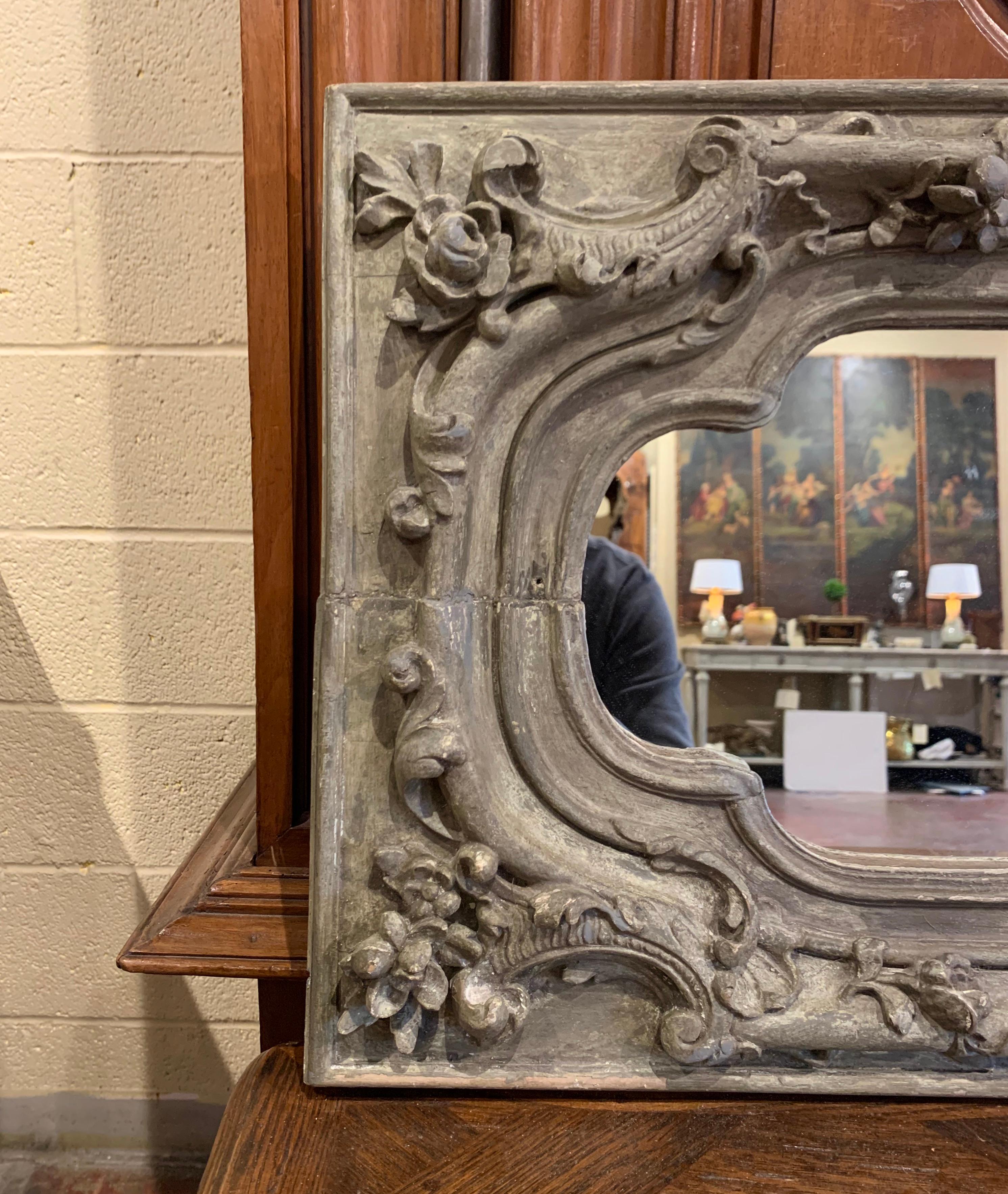 Crafted in France circa 1780, the versatile mirror can either be used vertically or horizontally. Hand carved in oak with old elements, the rectangular frame features scrolled decor embellished with acanthus leaf and floral motifs in high relief.