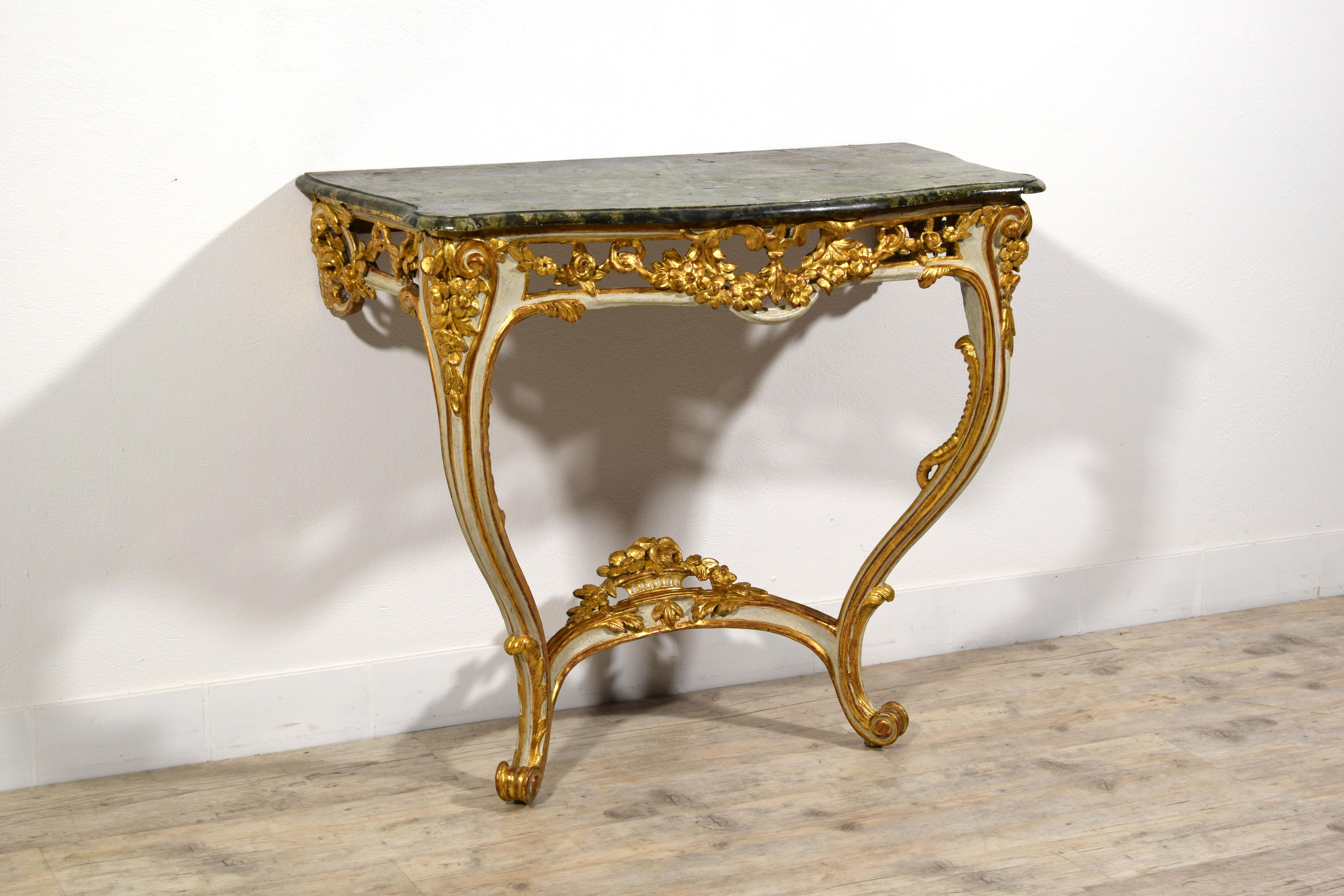 18th Century, French Louis XV Lacquered and Gilt Wood Console

This elegant console was crafted in the Louis XV period, 18th century, in France. It features a top with a shaped profile, made of lacquered wood with a faux marble effect in Green