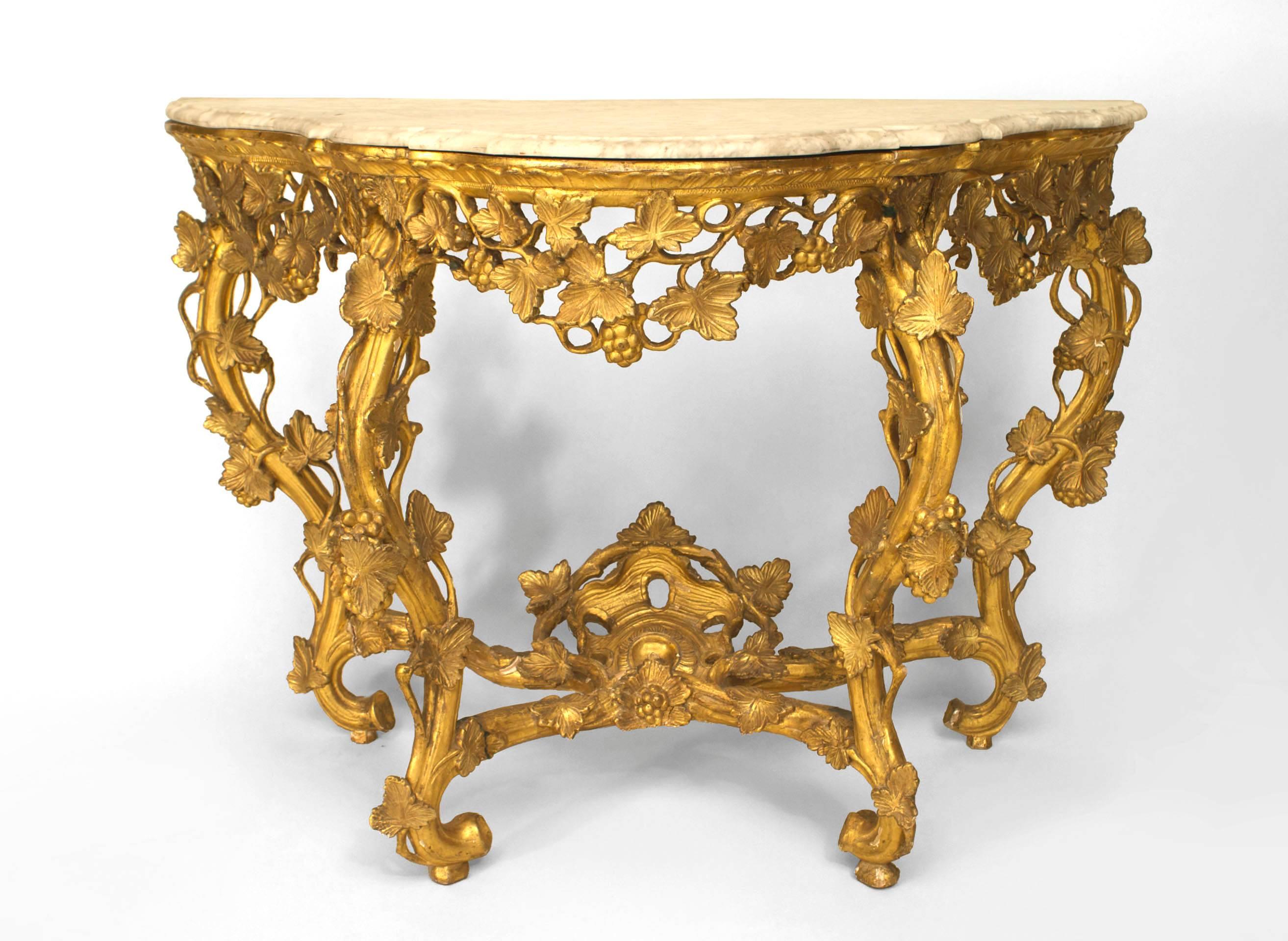 French Louis XV (18th Century) gilt console table with floral carved and filigree apron and legs with a stretcher and shaped white (rePaired) marble top.
