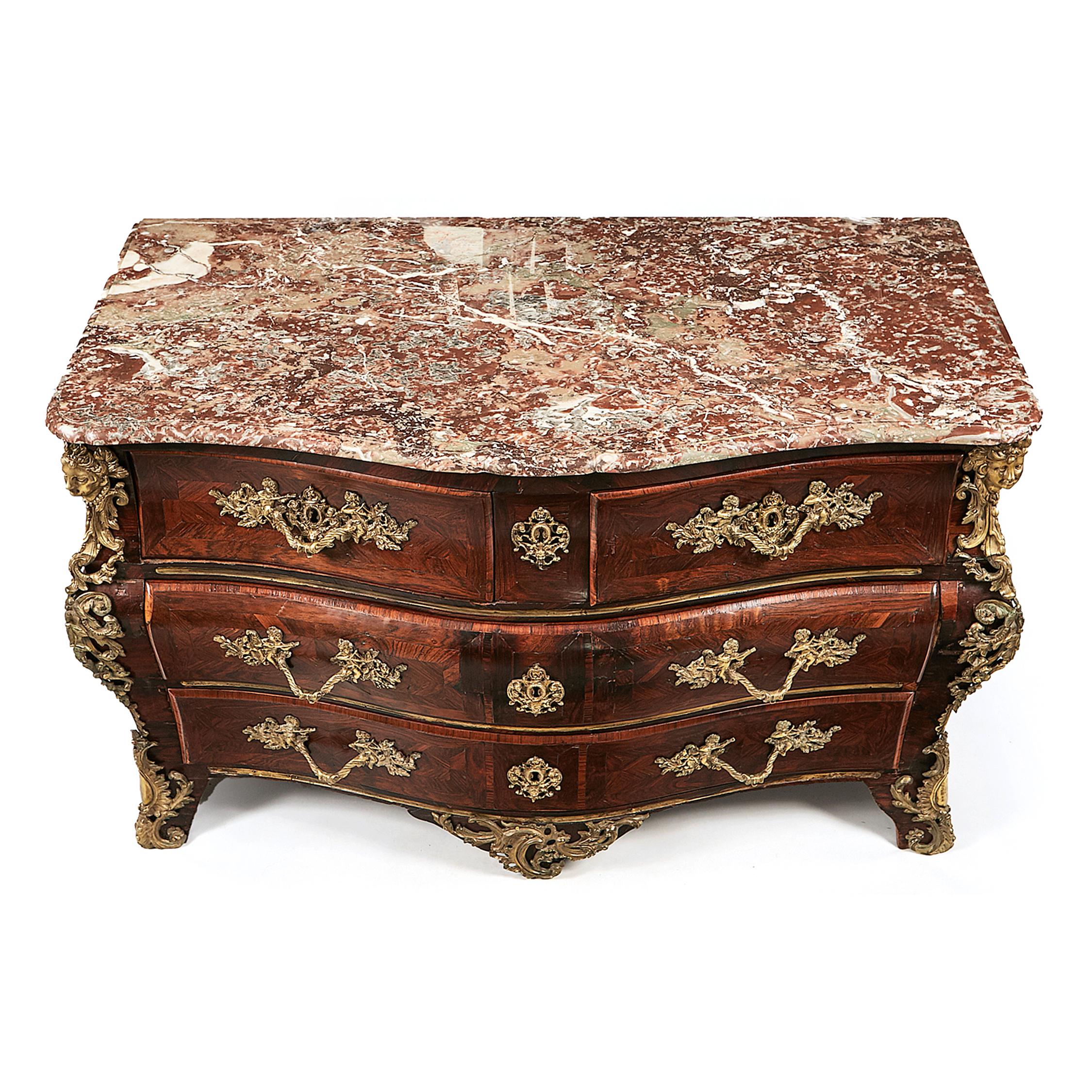This early 18th-century French Louis XV marquetry bombé commode or chest of drawers, with a carved signature 