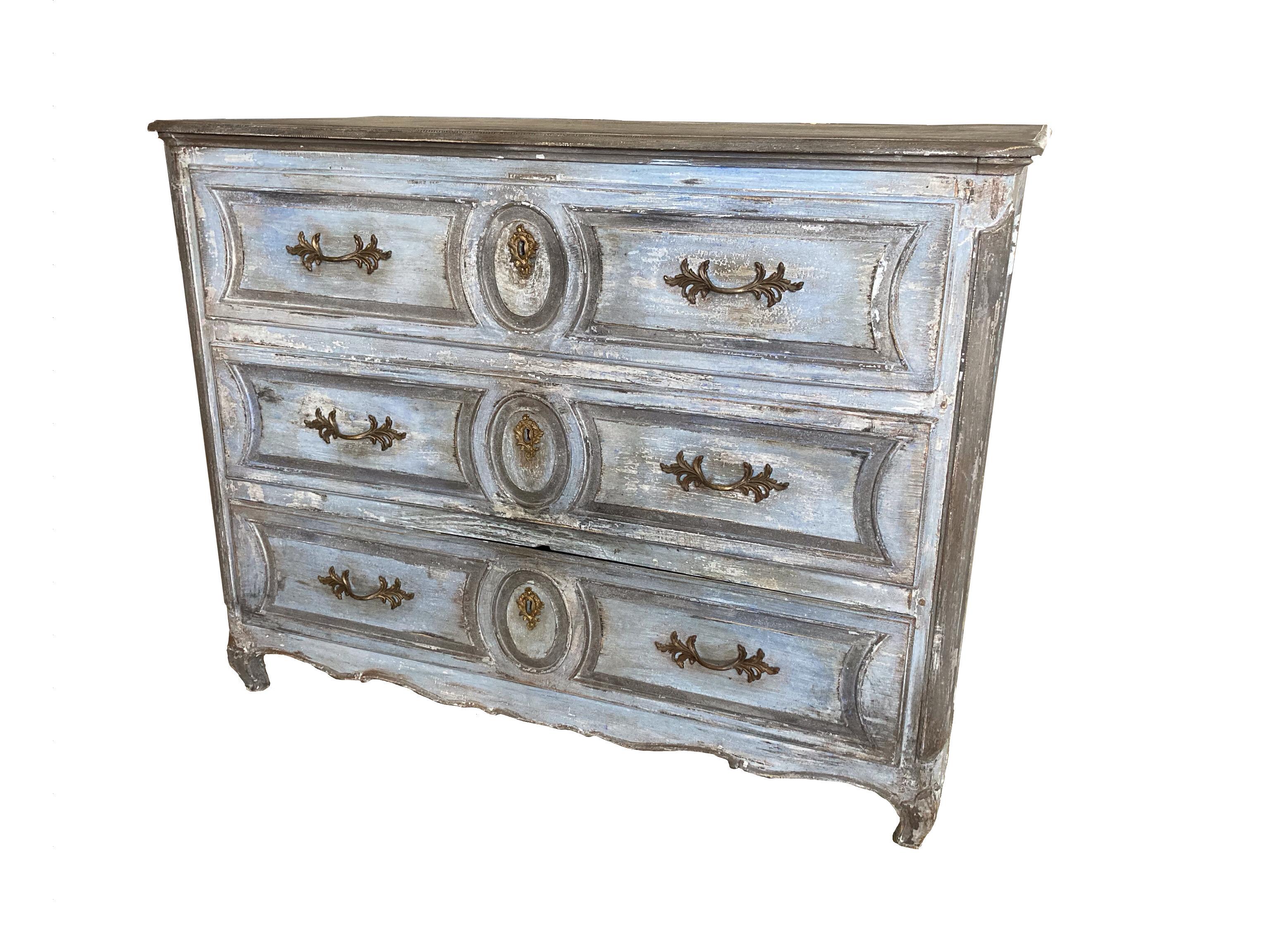 Painted Louis XV commode handmade in France in the mid 1700s using oak and pegged construction. The commode is a beautiful period piece with handmade large dovetail joints in the drawers as well as beautiful hand carved molding and details. The