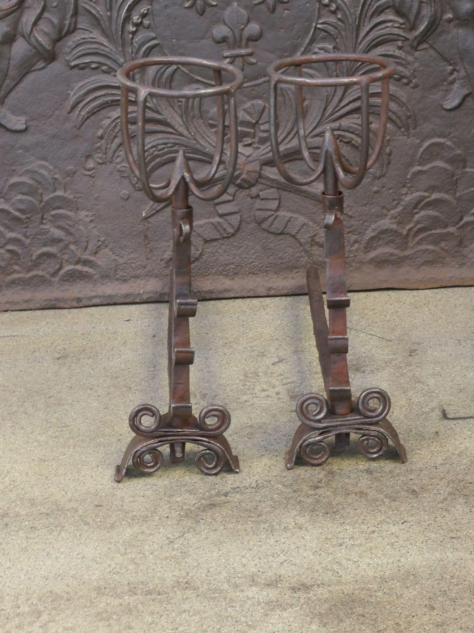 18th century French Louis XV Period andirons. The andirons are made of wrought iron and are beautifully forged and carved. They have spit hooks to grill food. The condition is good.