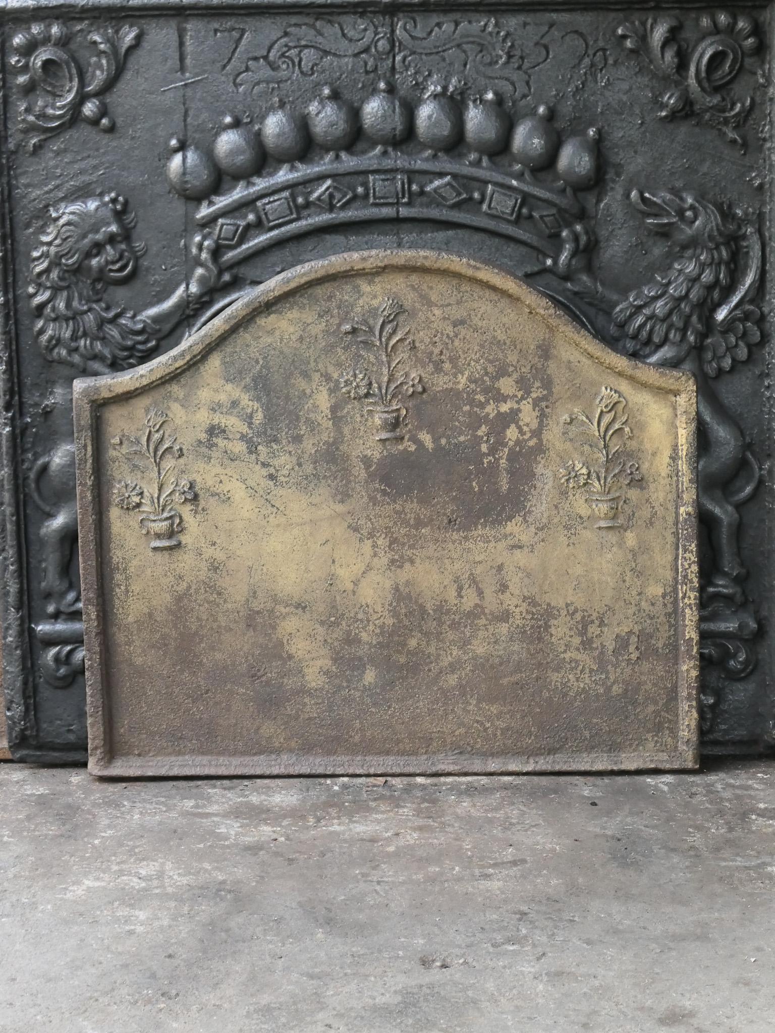 18th century French Louis XV period fireback. The decoration consists of three flower pots.

The fireback has a natural brown patina. Upon request it can be made black / pewter colored at no extra cost. The fireback is in a good condition and does