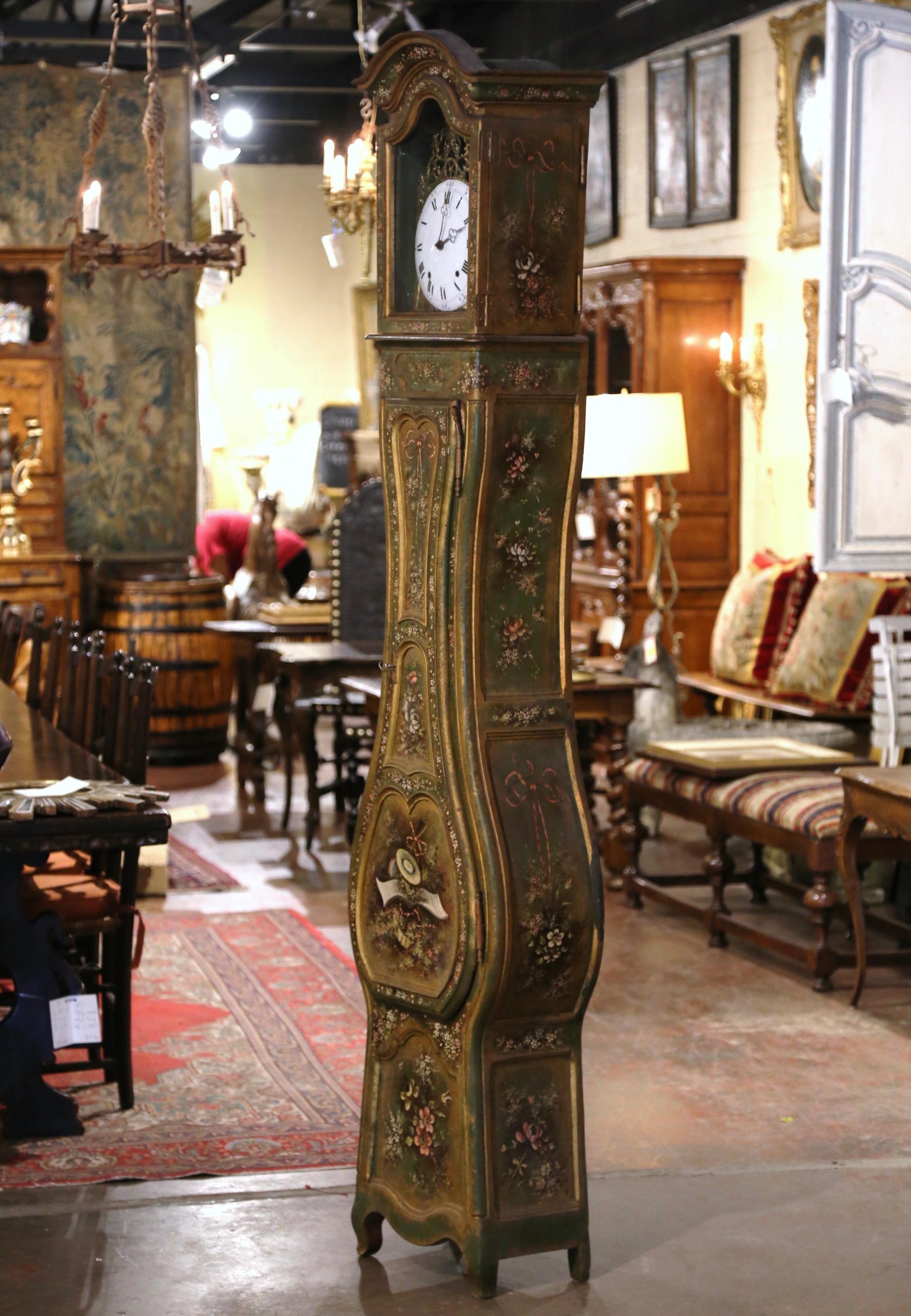 Crafted in Provence, southern France, circa 1790 and built in one section, the antique hand painted tall case clock stands on curved feet over a scalloped apron, and features beautiful lines including a bonnet top over a violin shape body. The
