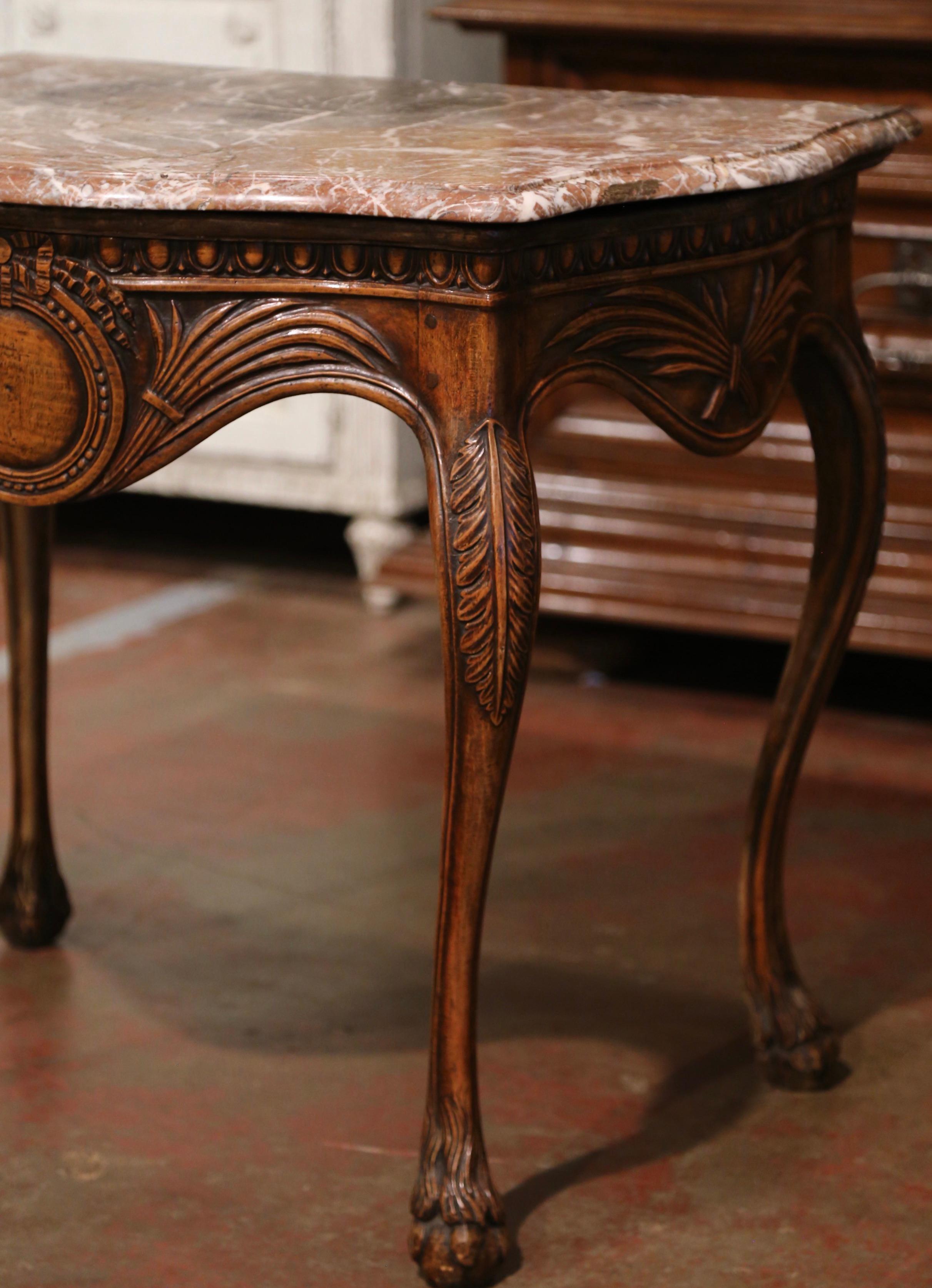Decorate a bedroom, entryway or a living room with this elegant antique console table. Created in Southern France circa 1760, the delicate fruit wood table stands on cabriole legs decorated with acanthus leaves at the shoulder, and ending with paw
