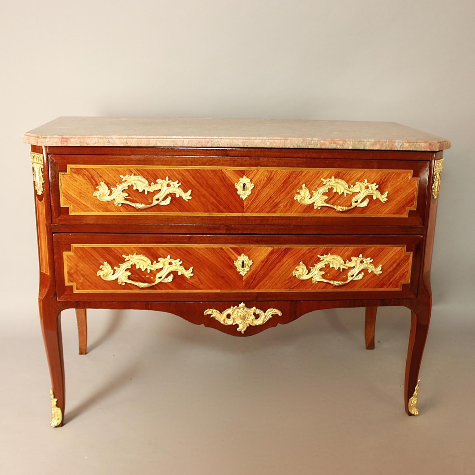 18th Century French Louis XV/Transition Marquetry Gilt Bronze Commode

An 18th century gilt bronze-mounted marquetry transition style commode with a moulded marble top above two long drawers, each veneered à deux faces and inlaid with geometric