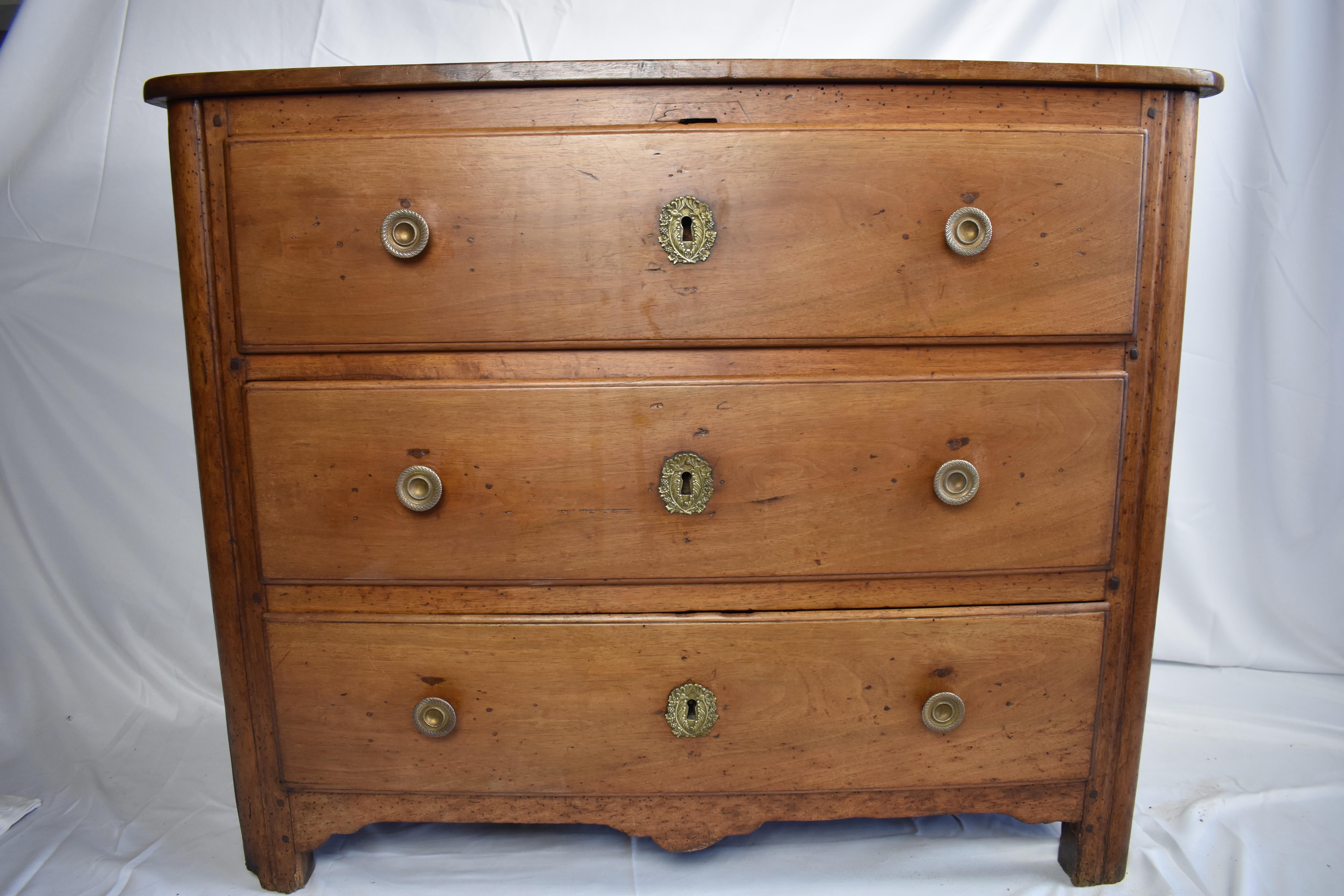 This is a beautiful period piece, built using pegged construction, walnut and oak secondary. This little guy is sturdy, and roomy. The commode still sits on its original feet, however, the hardware was changed at some point in the past. The drawers