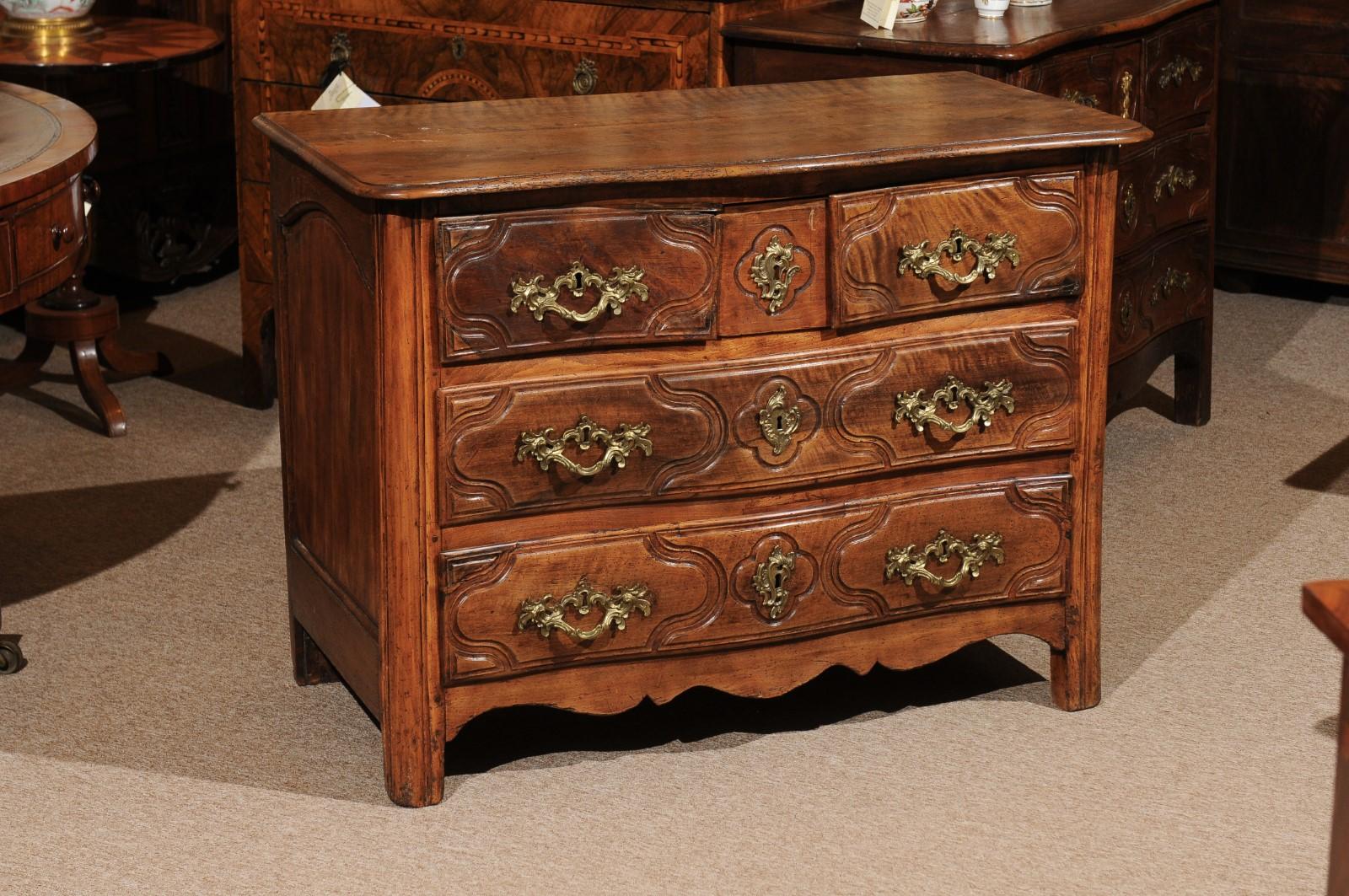 Louis XV period walnut commode with shaped apron and five (5) carved drawers--2 full width drawers below two small and one hidden/secret drawer, 18th century, France.